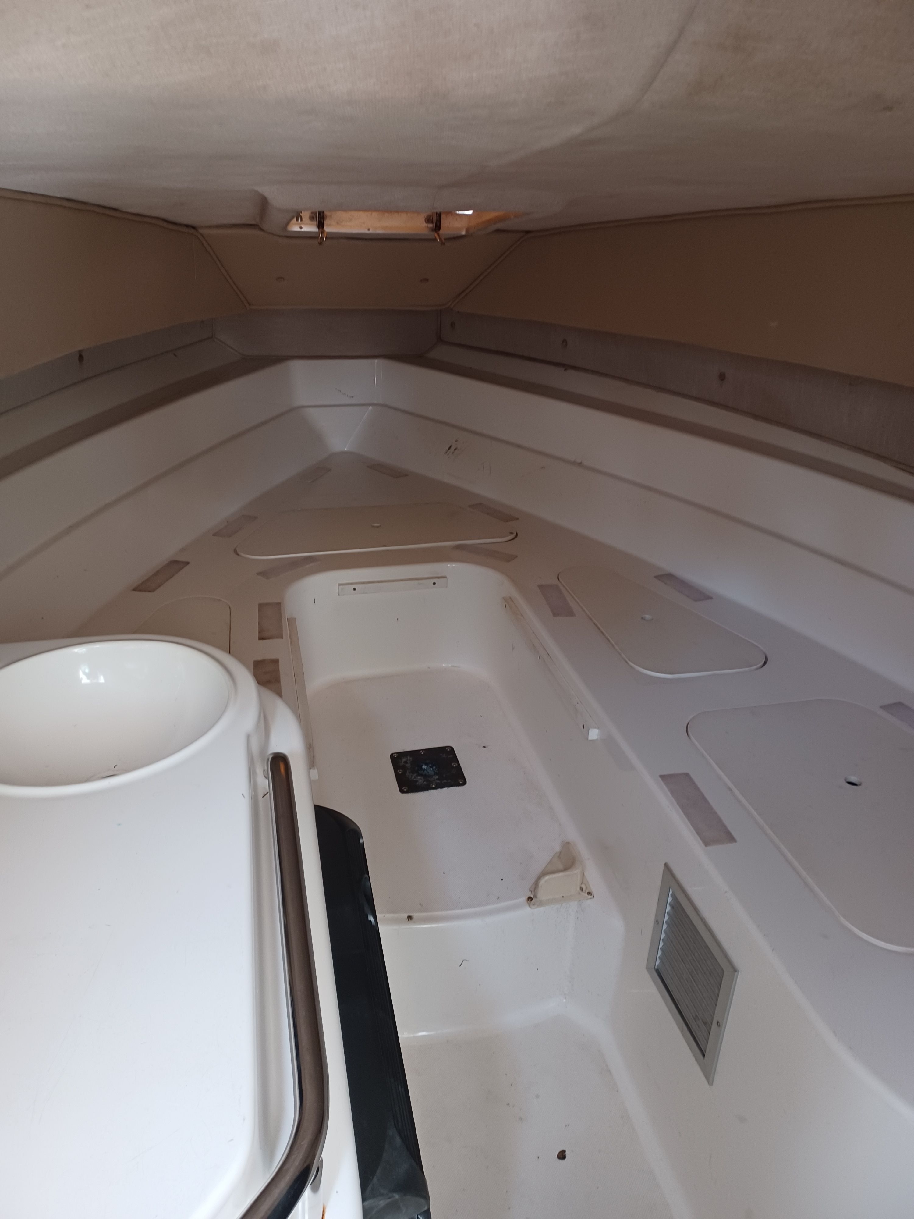 Interior of a 1995 Fountain 31 SFC with white walls and a sink.