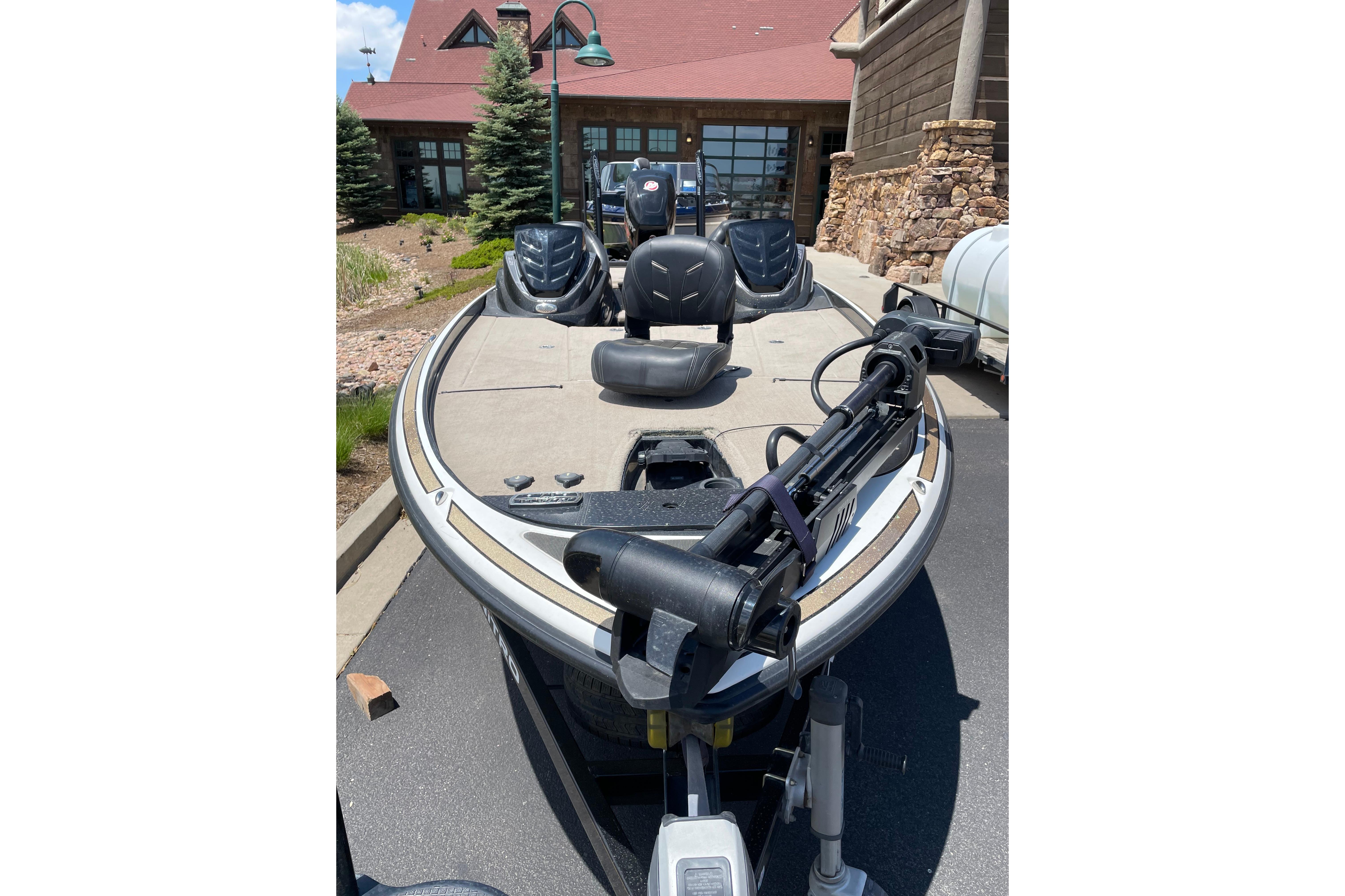 2016 Nitro Z21 fishing boat parked near a rustic building.