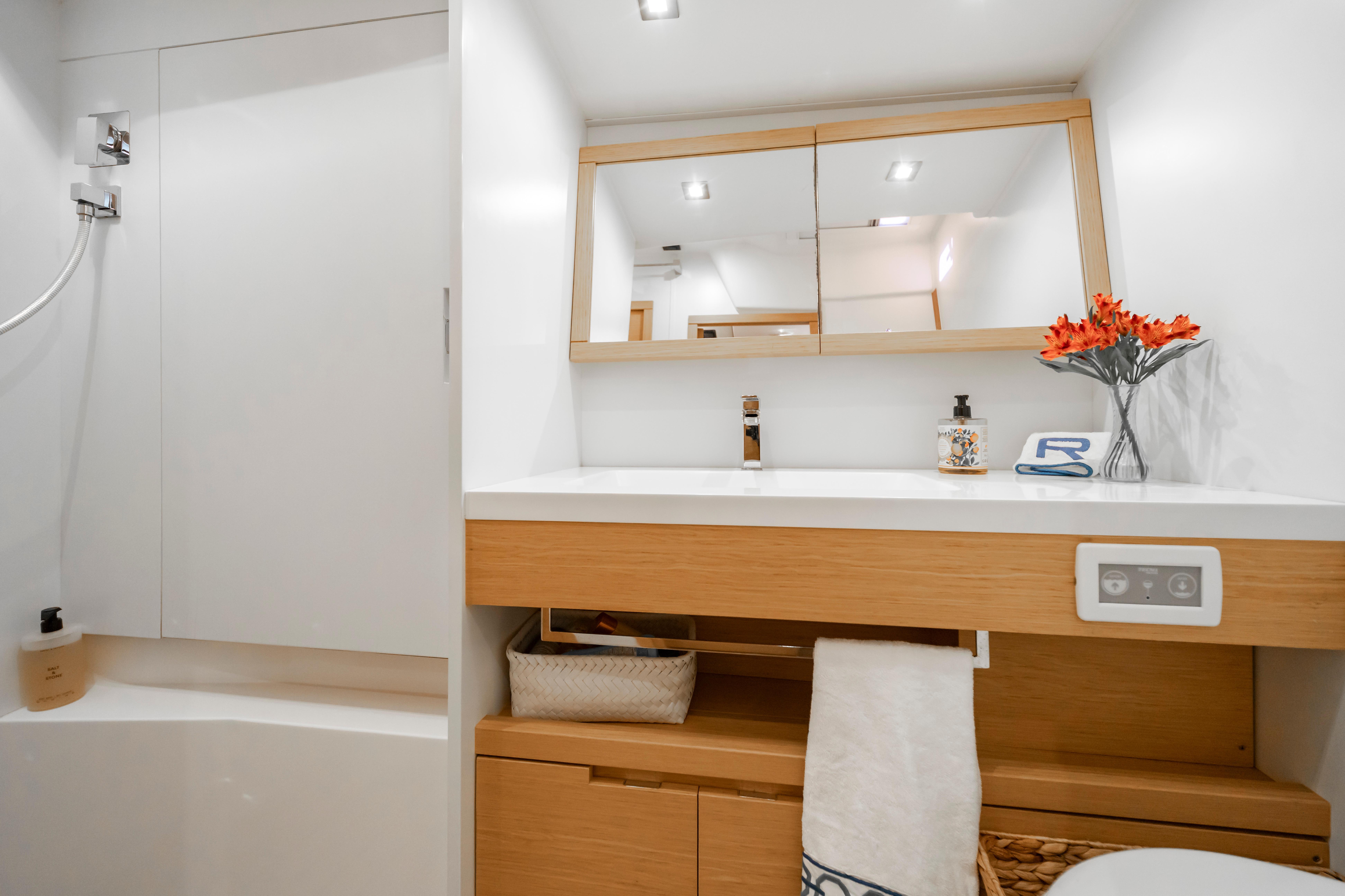 Modern bathroom interior on a 2016 Grand Soleil 58 yacht, featuring sleek design and wooden accents.