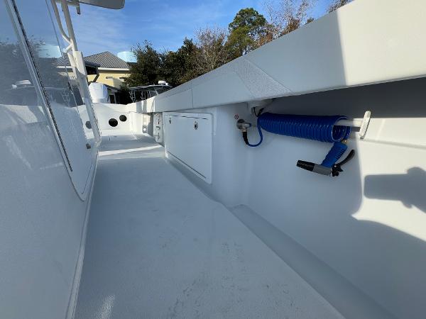 2025 Yellowfin 39 Offshore boat deck with storage and coiled hose.