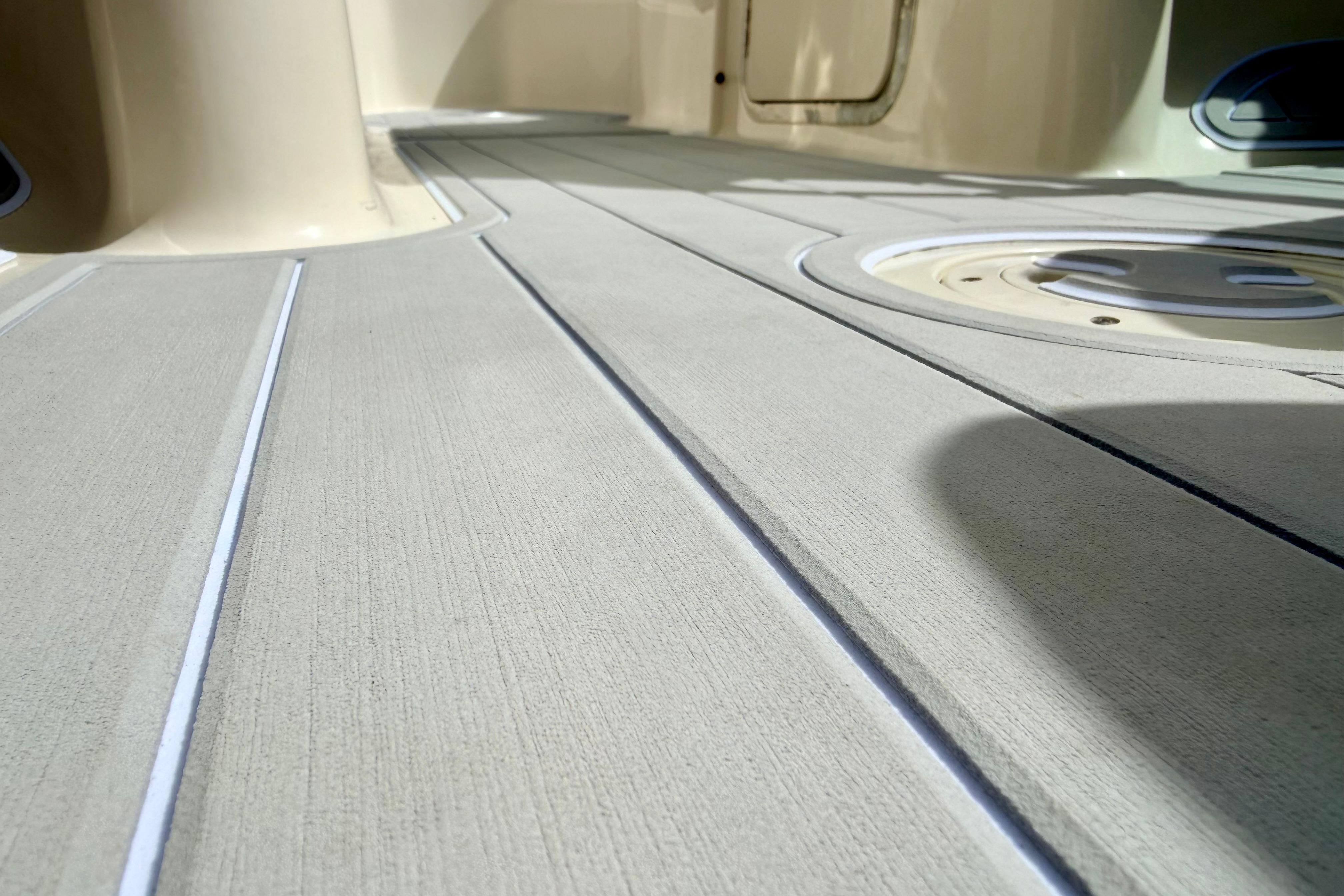 Close-up of 2003 Sea Ray 200 Sundeck boat deck with textured surface.