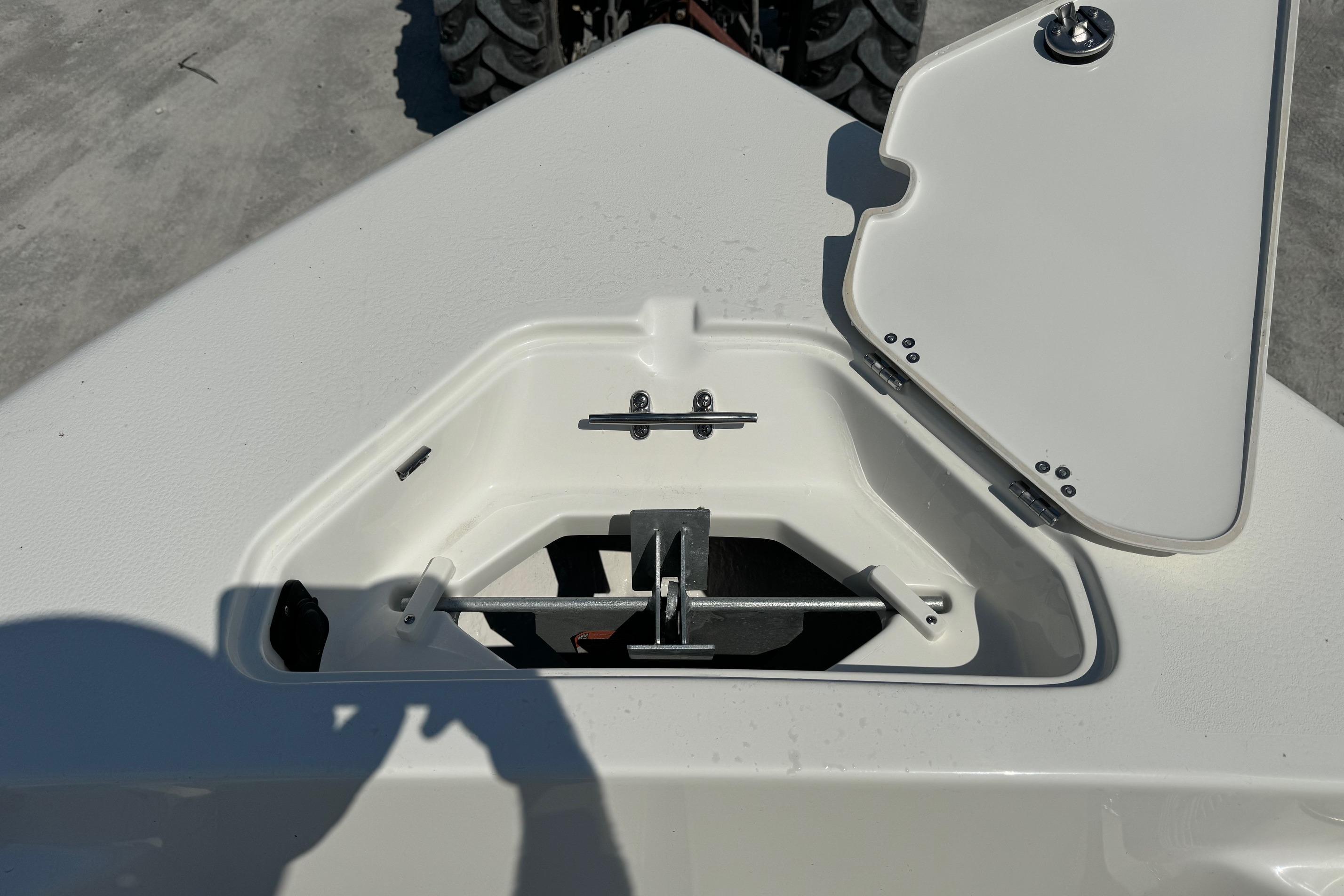 Open storage compartment on 2025 Key West 203 FS boat, showing interior details.