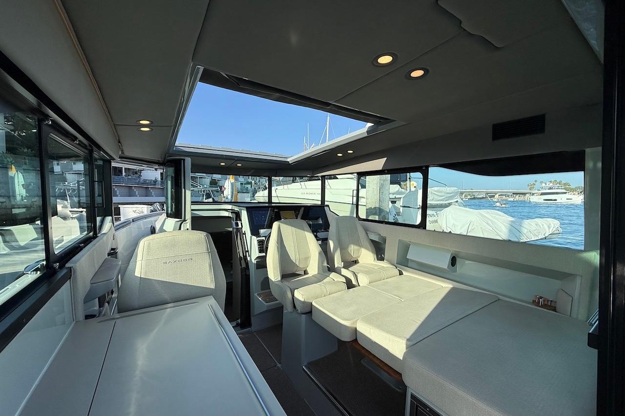 Interior of 2024 Saxdor 320 GTC boat, featuring modern seating and panoramic windows.