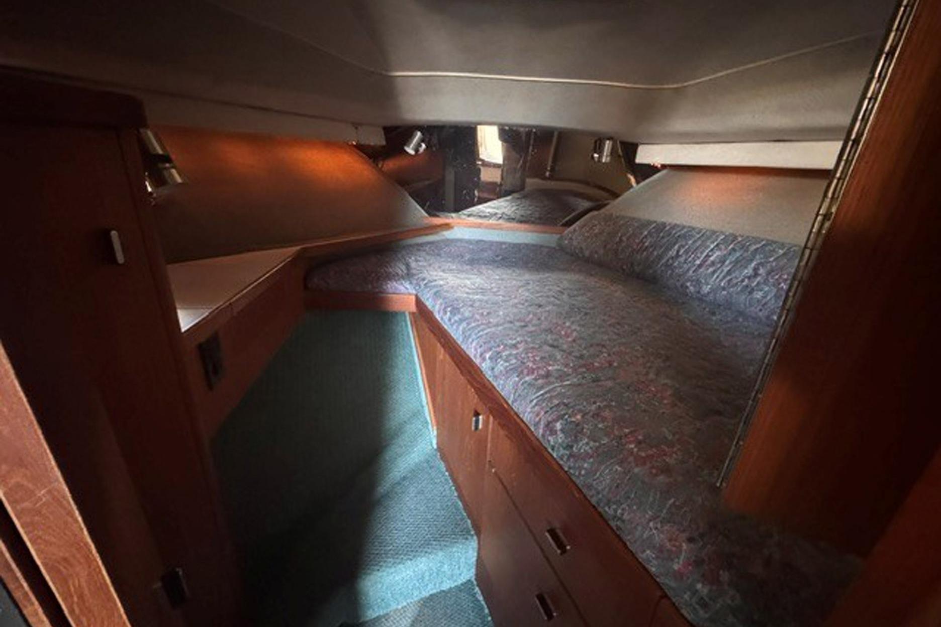 Interior cabin of 1988 Tiara Yachts 3300 Open, featuring cozy sleeping quarters.