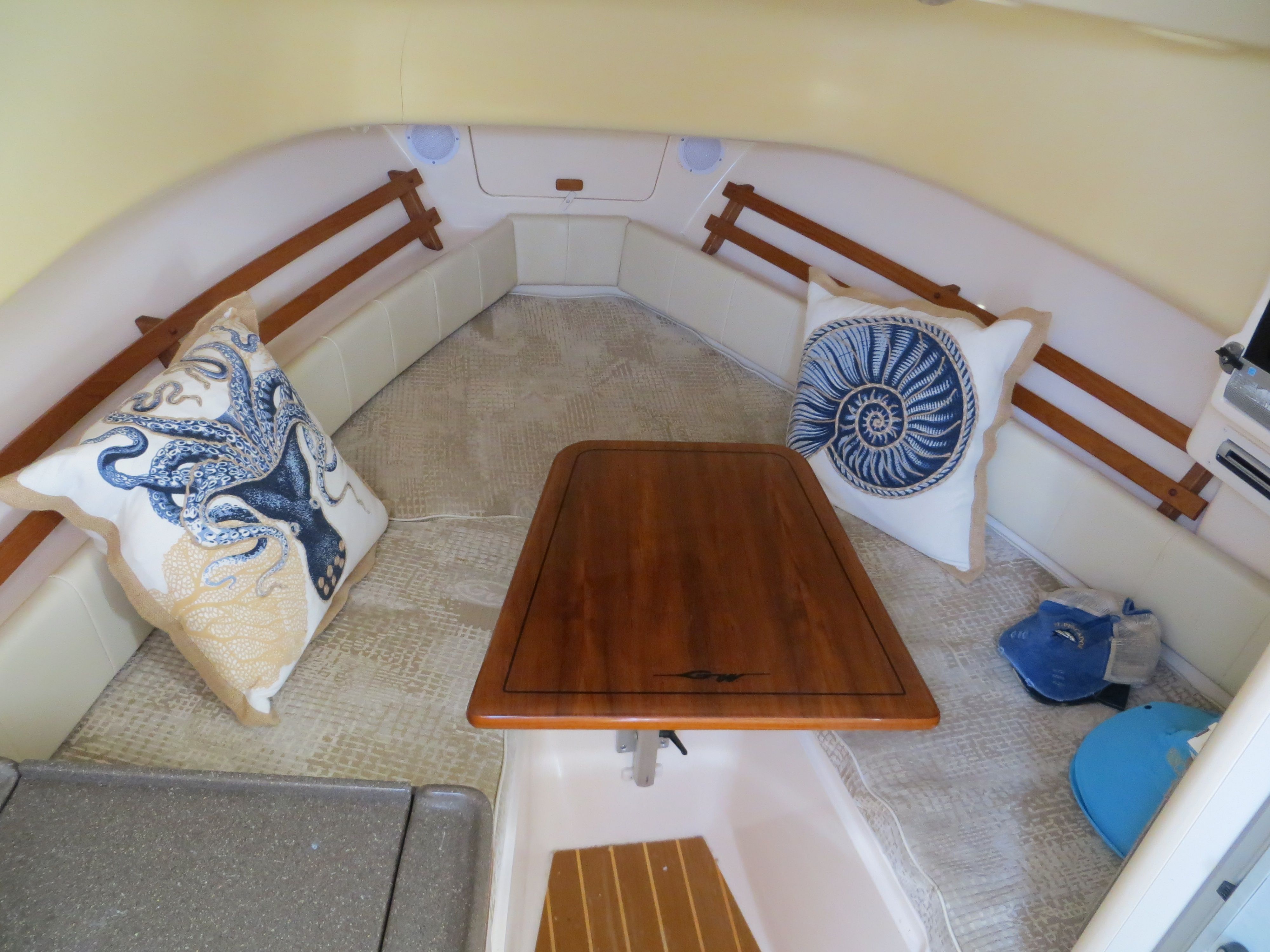 Interior of the Grady-White Sailfish 282 with table and cushions.