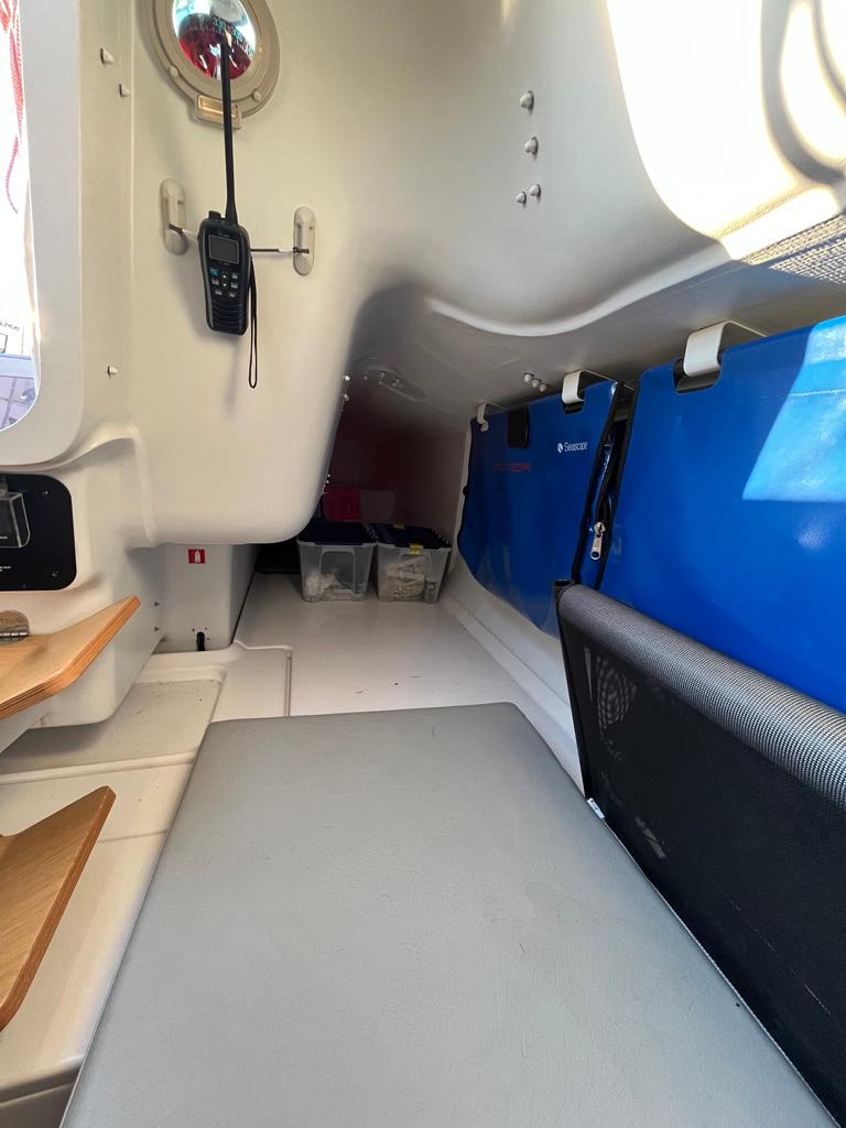 Interior of a 2018 Seascape 27 sailboat, featuring compact cabin space and storage.