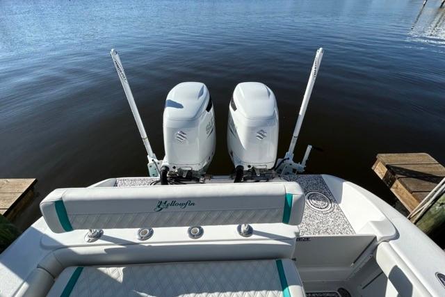 2002 Yellowfin 31 Center Console boat with twin Suzuki outboard motors on calm water.