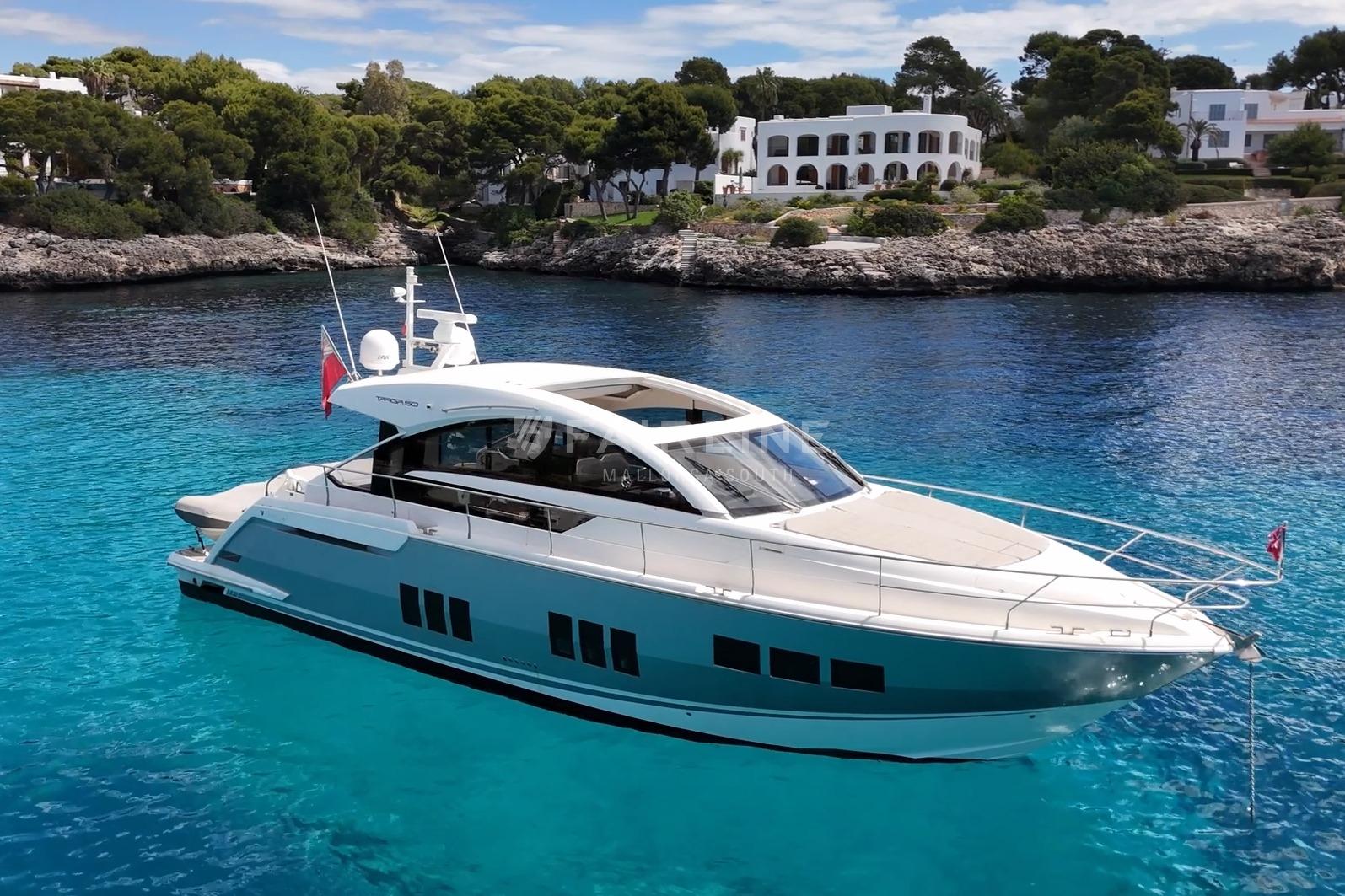Luxury Fairline Targa 50 GT yacht, 2012 model, anchored in clear blue waters.
