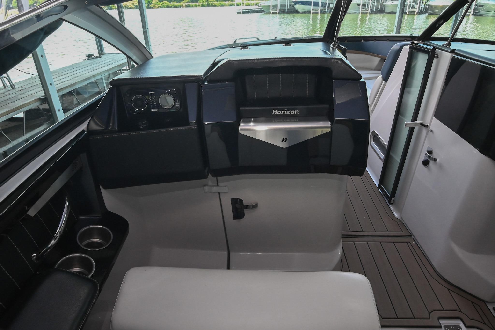 Interior of 2014 Four Winns H290 boat, featuring sleek dashboard and modern controls.