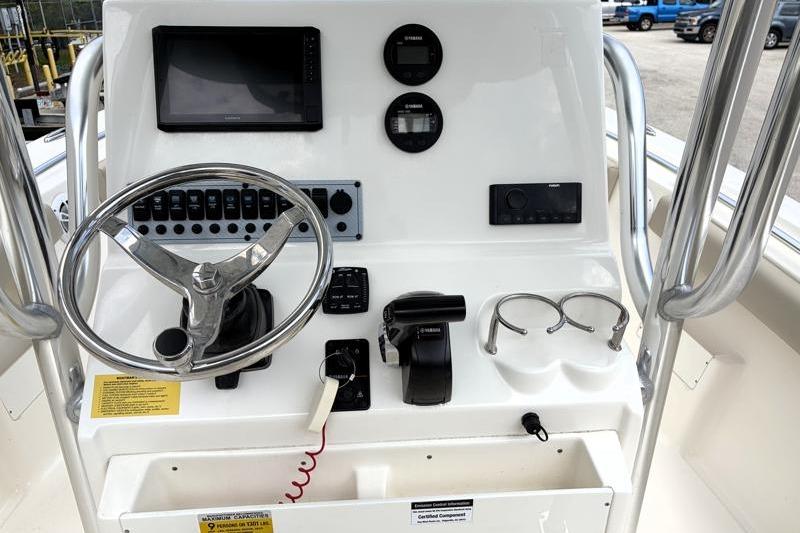 2024 Key West 239 FS boat console with steering wheel, gauges, and controls.