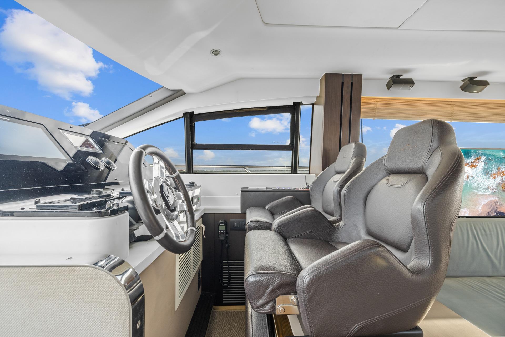 Interior cockpit of 2019 Azimut 55 yacht with modern steering and seating.