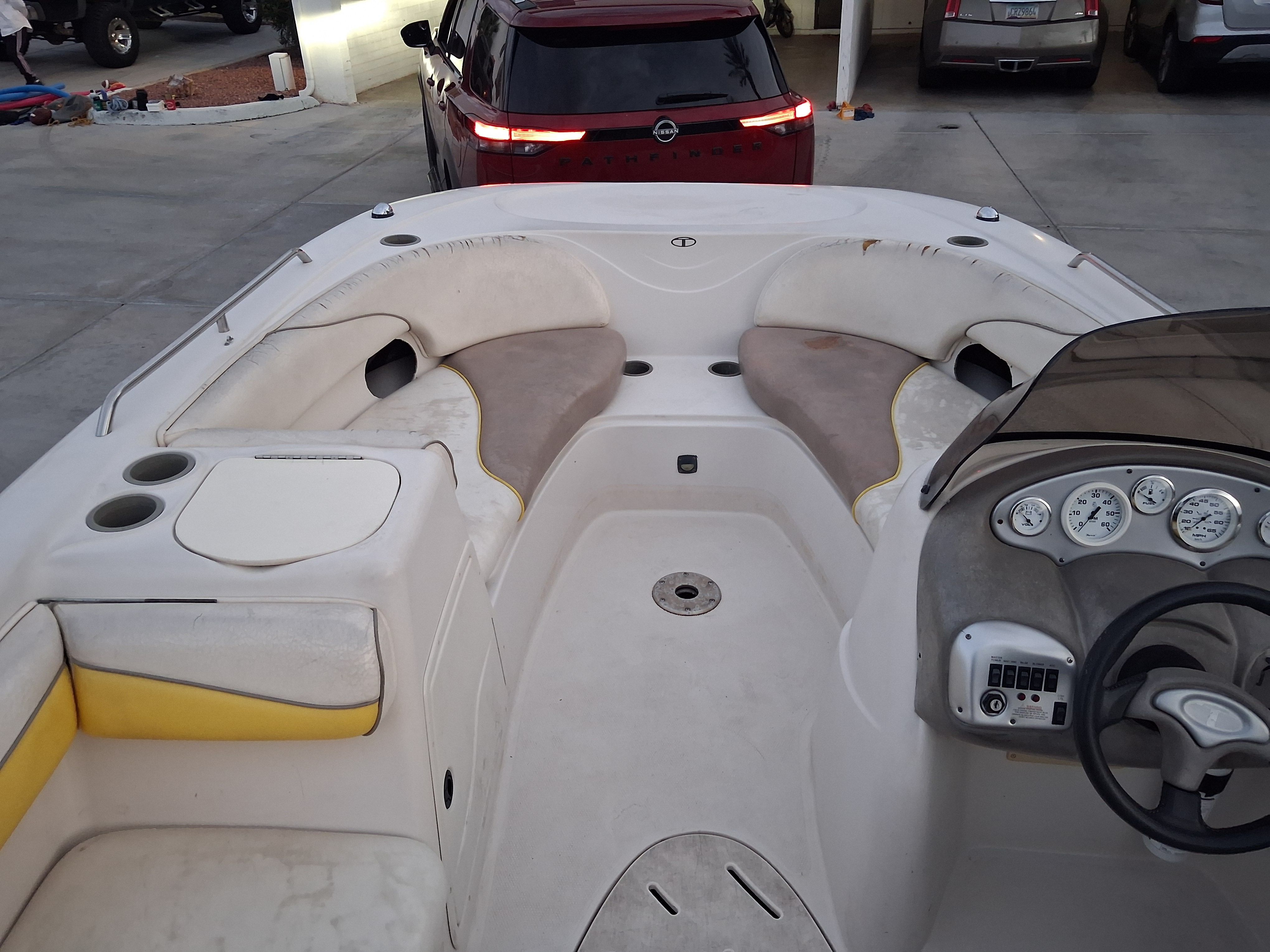 Interior of a 2004 Tracker Tahoe boat with seating and dashboard.