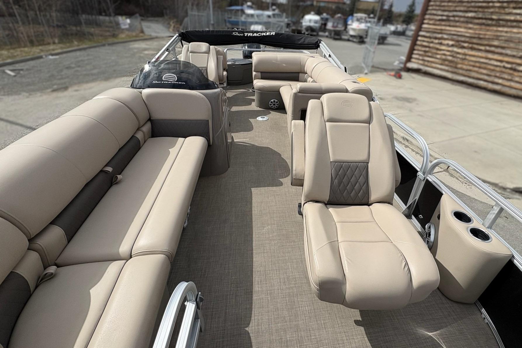 2023 Sun Tracker SportFish 20 DLX pontoon boat with beige seating and spacious interior.