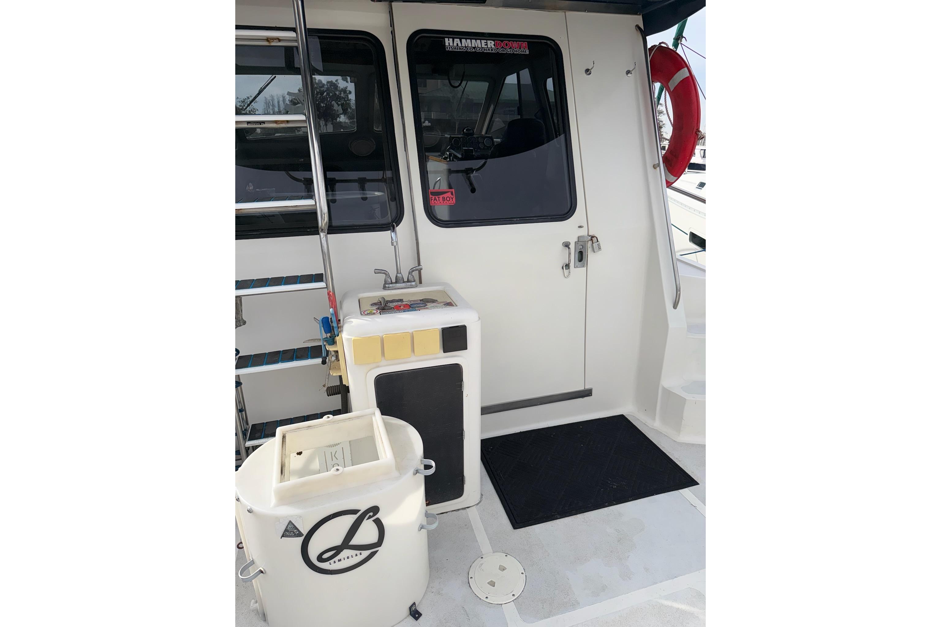 1990 Mediterranean Sport Fish boat deck with equipment and safety gear.