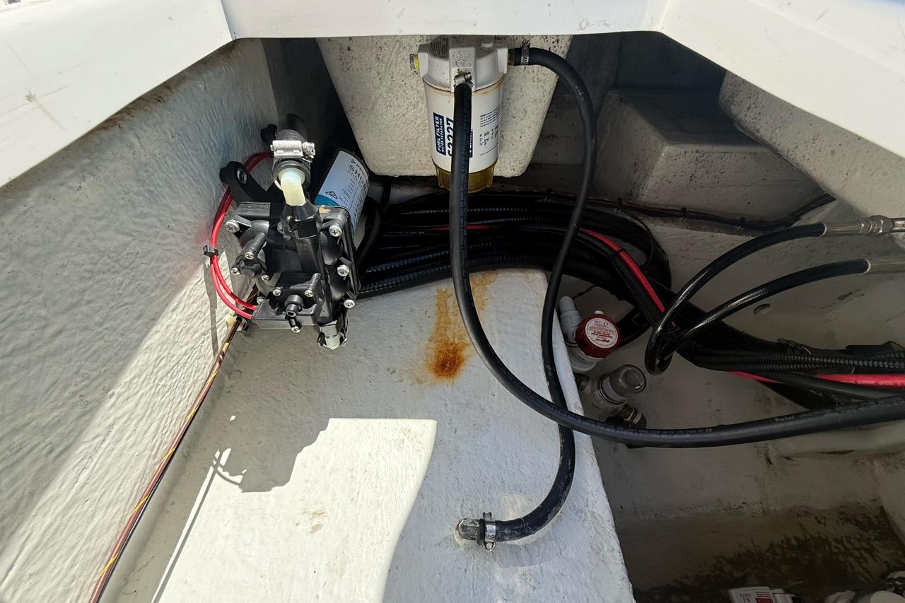 2021 Custom Infusion 34 CC boat engine compartment with fuel filter and wiring.