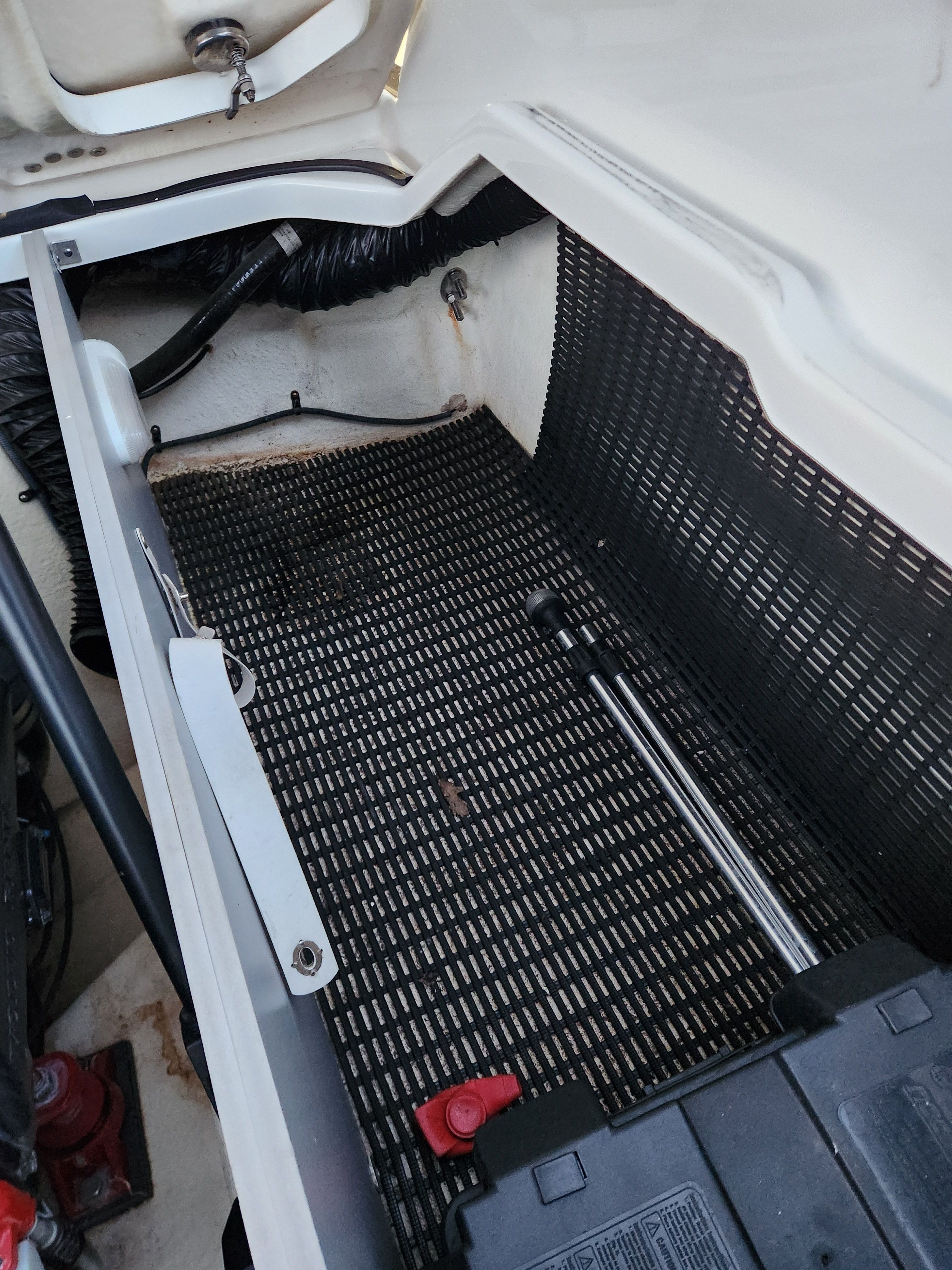 Interior of 2015 Monterey 268SSC boat, storage compartment with tool.