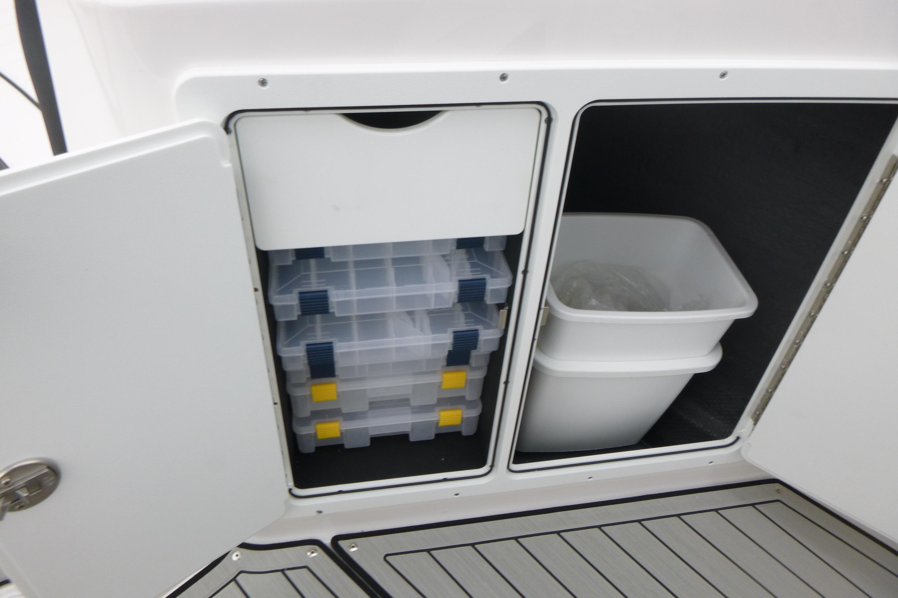 Storage compartments on 2026 Yamaha Boats 255 FSH Sport H, featuring organized bins and containers.
