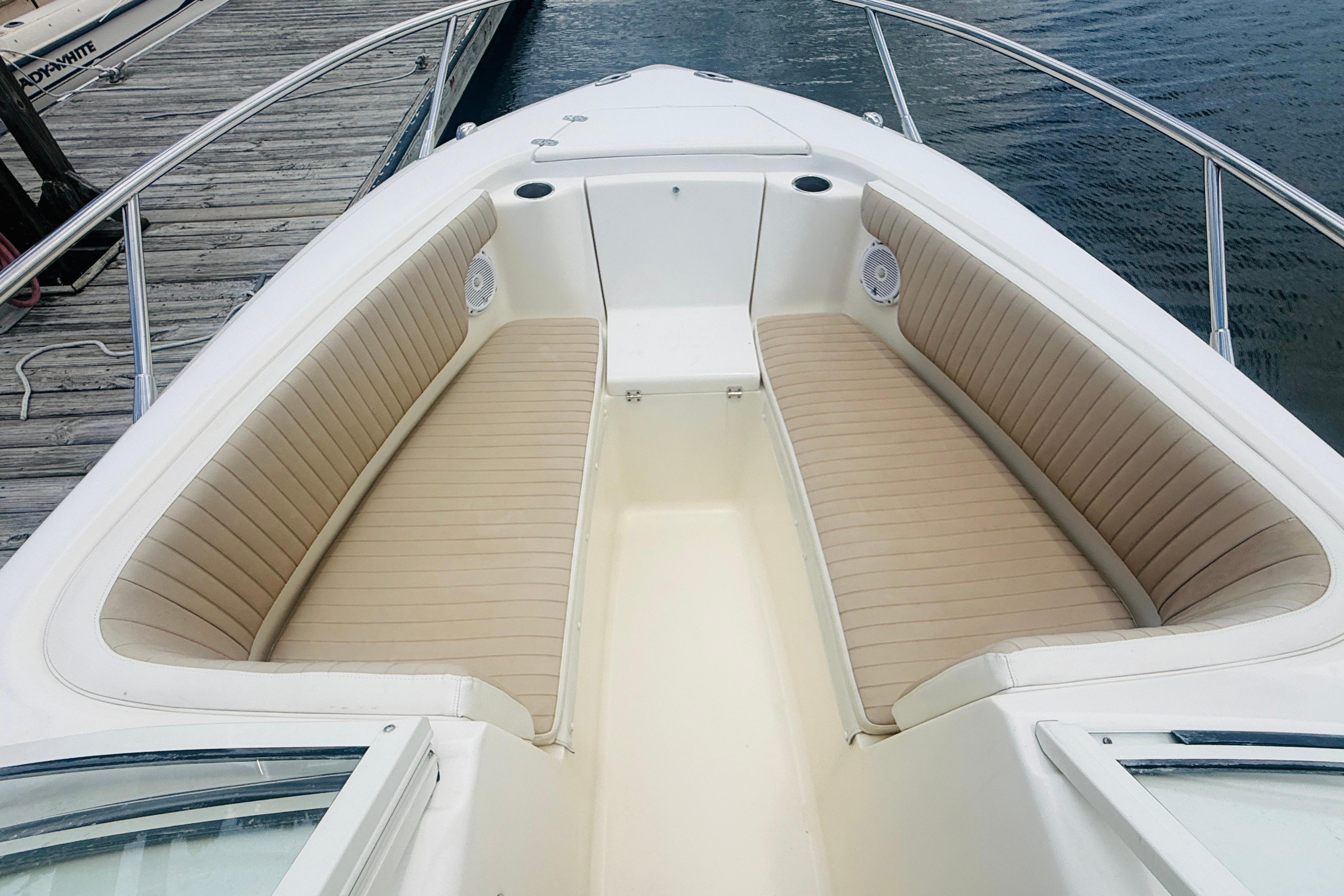 2012 Scout 245 Dorado boat interior with beige seating and waterfront view.