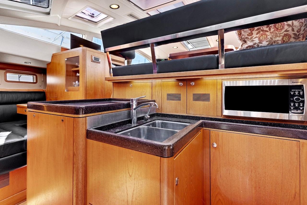 Luxurious interior of 2011 Southerly 57 RS yacht featuring modern kitchen amenities.