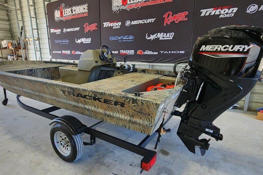 2026 Tracker Grizzly 1648 SC boat with Mercury engine in showroom.