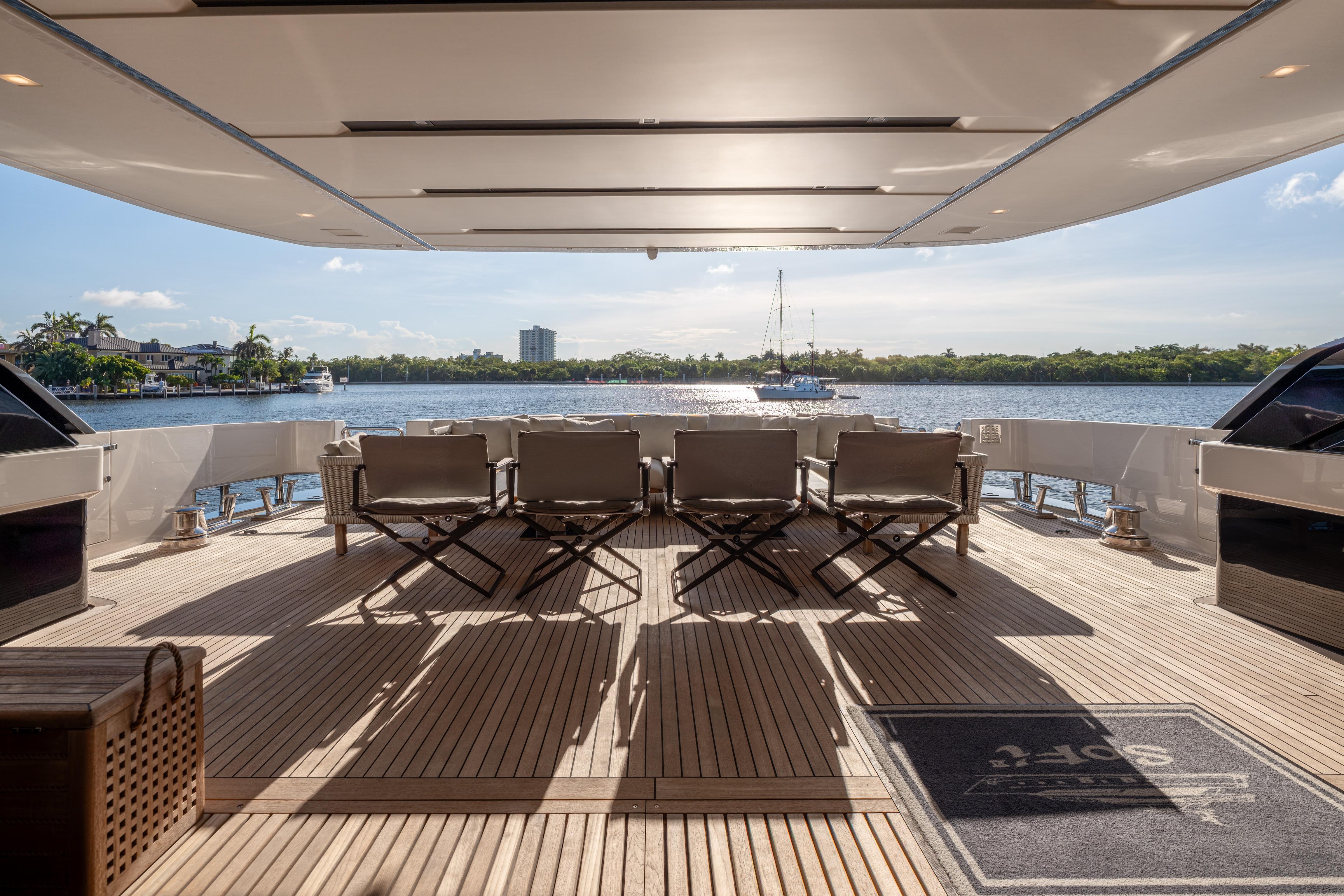 Luxurious 2023 Sanlorenzo SL120A yacht deck with elegant seating and scenic waterfront view.