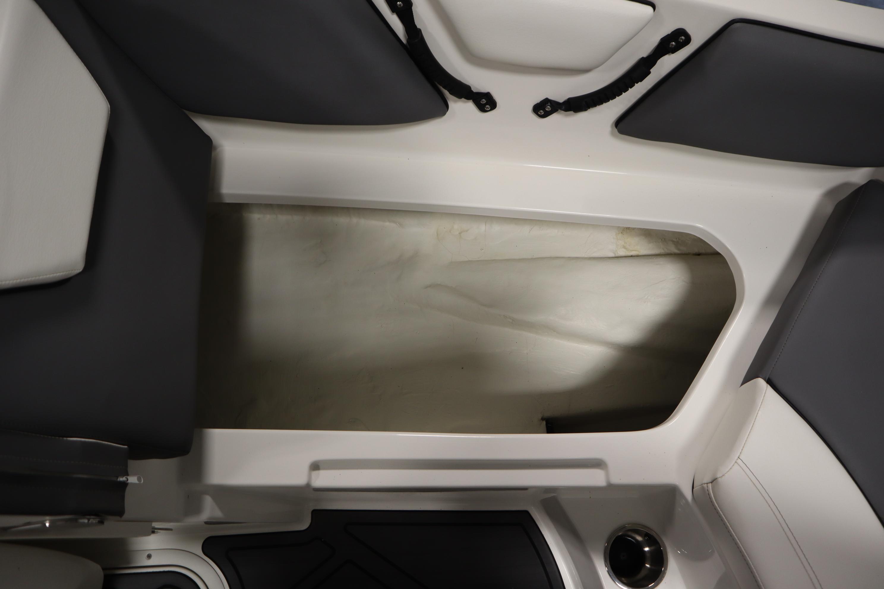 2023 Heyday WT Surf boat interior storage compartment with sleek design and dark upholstery.