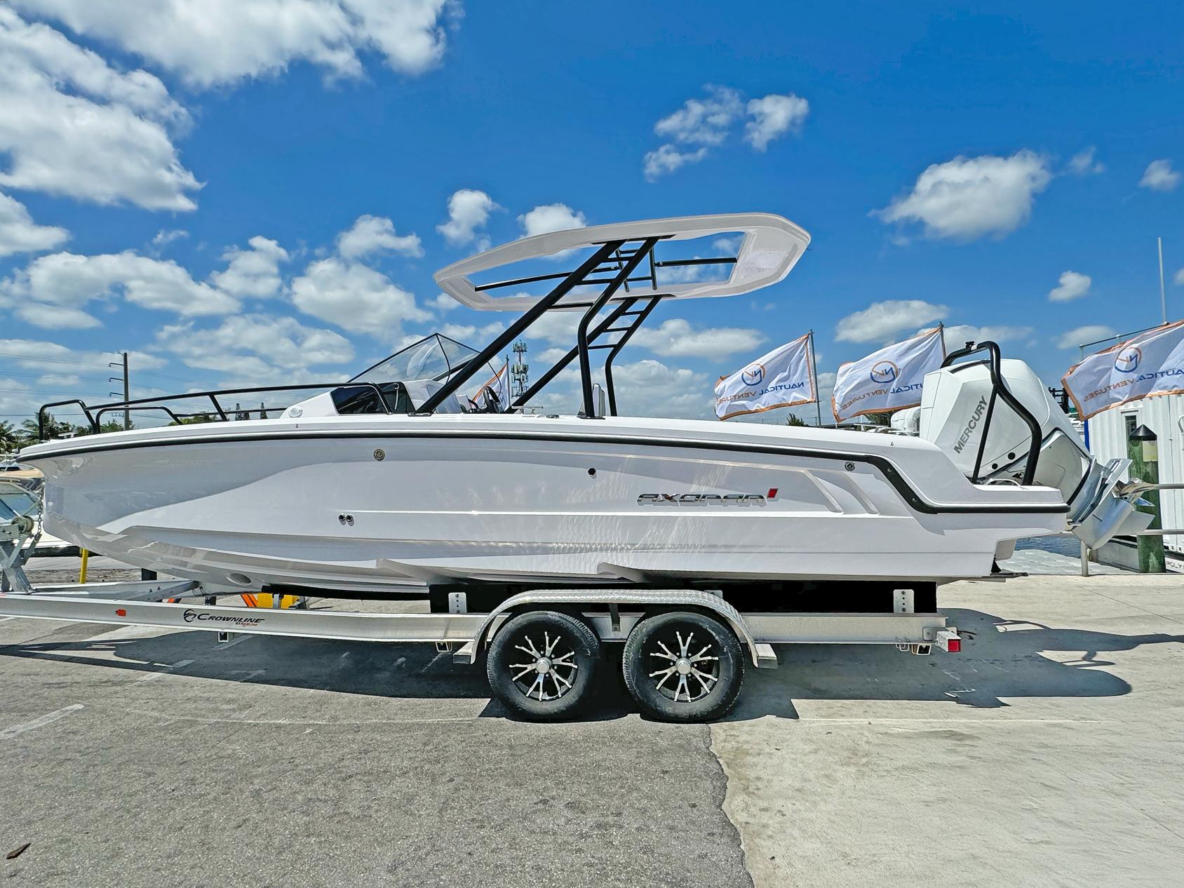 2024 Axopar 25 Cross Top boat on trailer under blue sky.