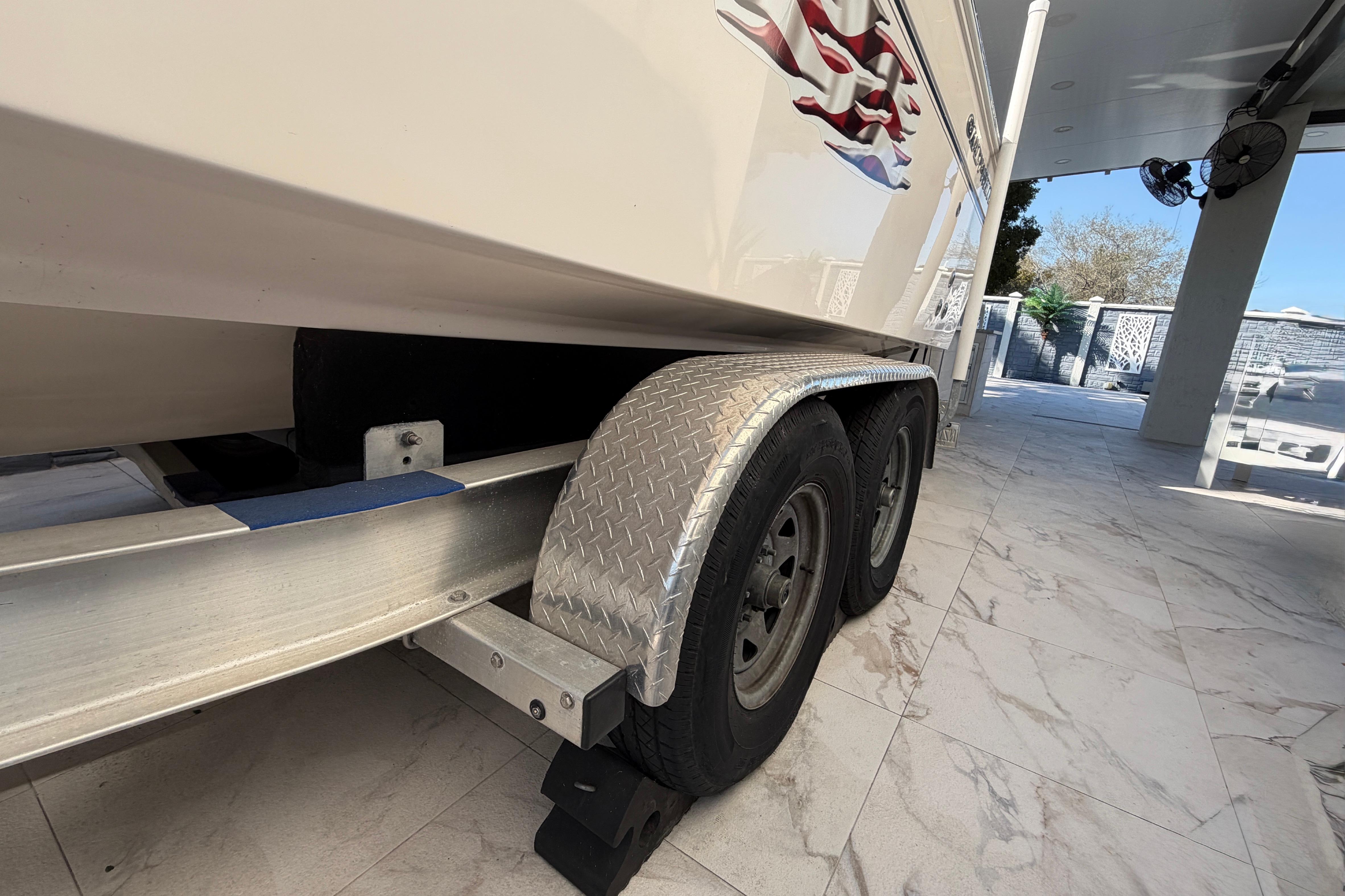 2004 Grady White 273 boat on trailer, parked on tiled surface.