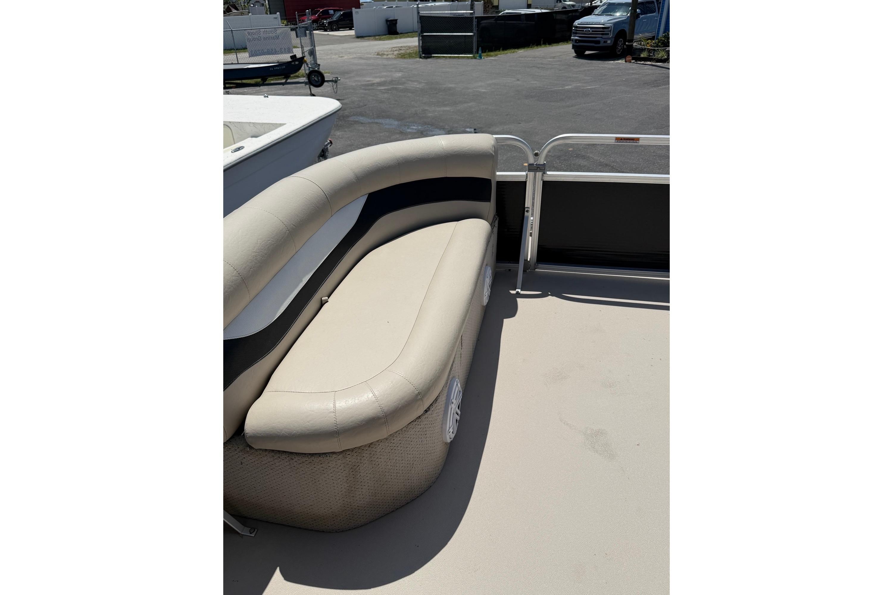 2014 Avalon 1900 boat interior with beige seating and spacious deck area.