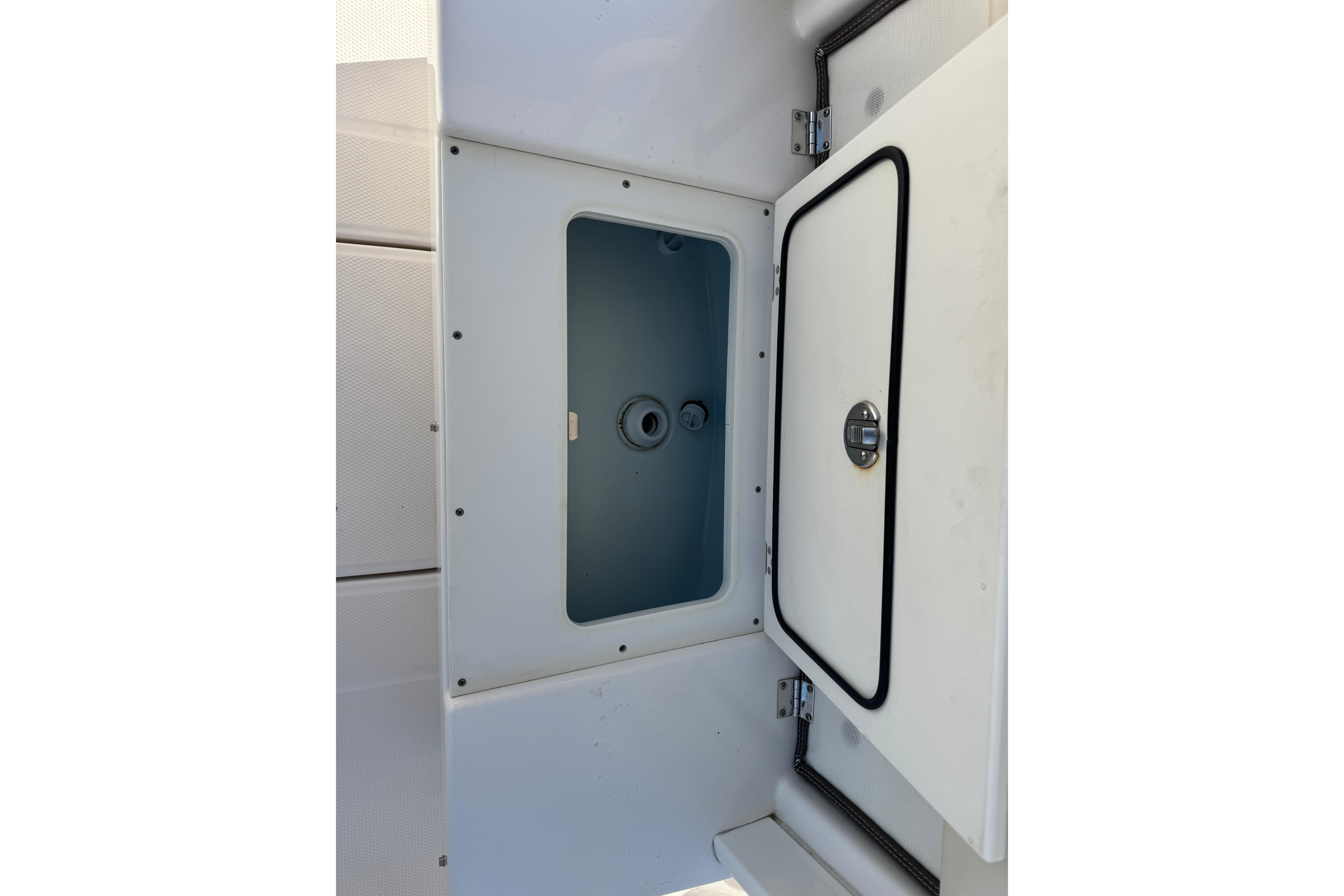 2020 Robalo R272 Center Console storage compartment with open hatch.