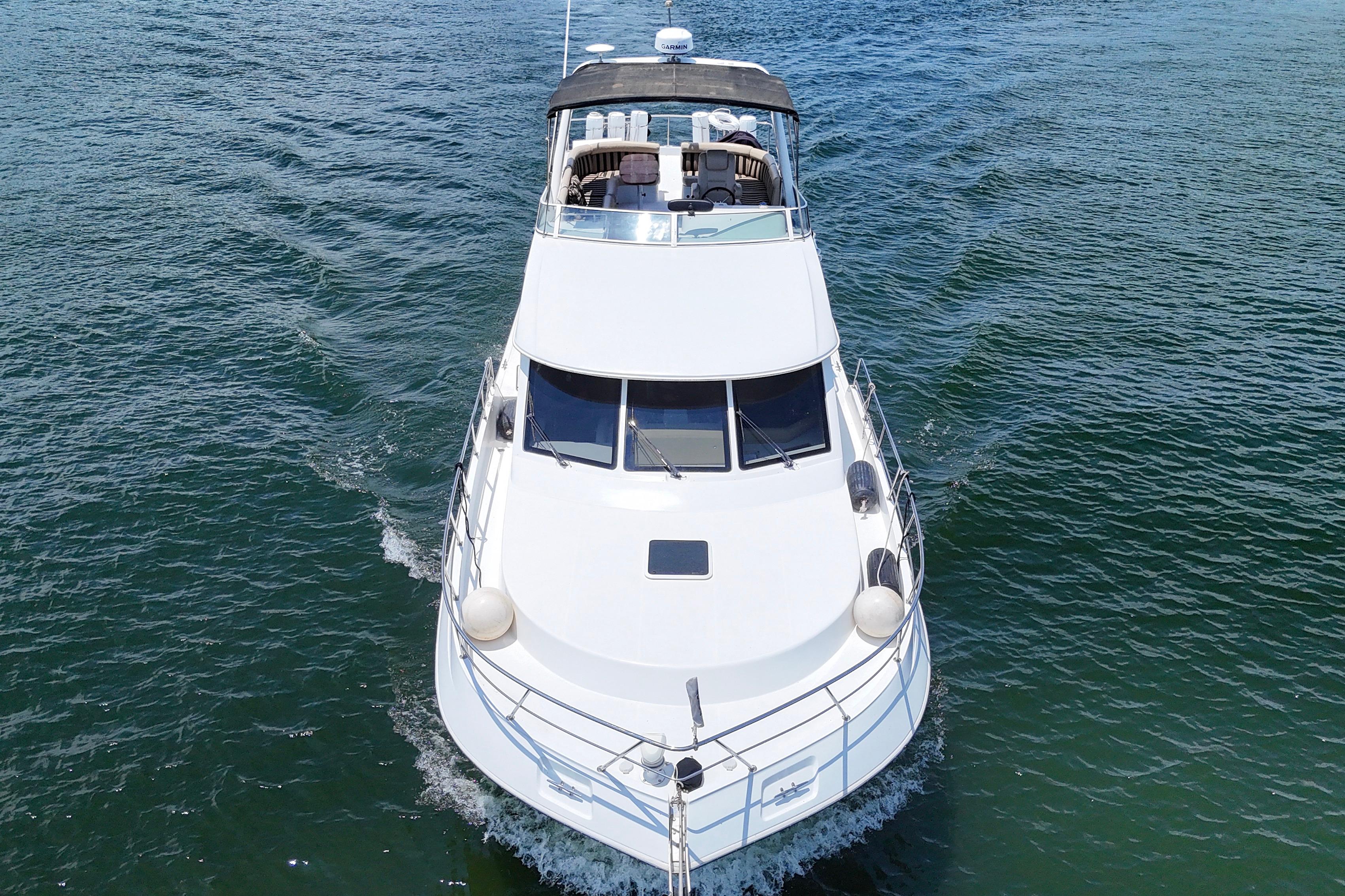 2007 Navigator 5100 yacht cruising on open water, aerial front view.