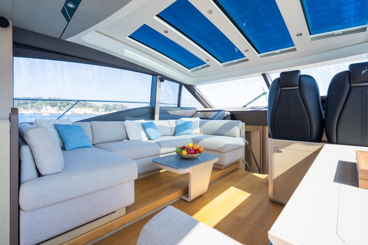 Luxurious interior of 2019 Princess V60 yacht with modern seating and panoramic windows.
