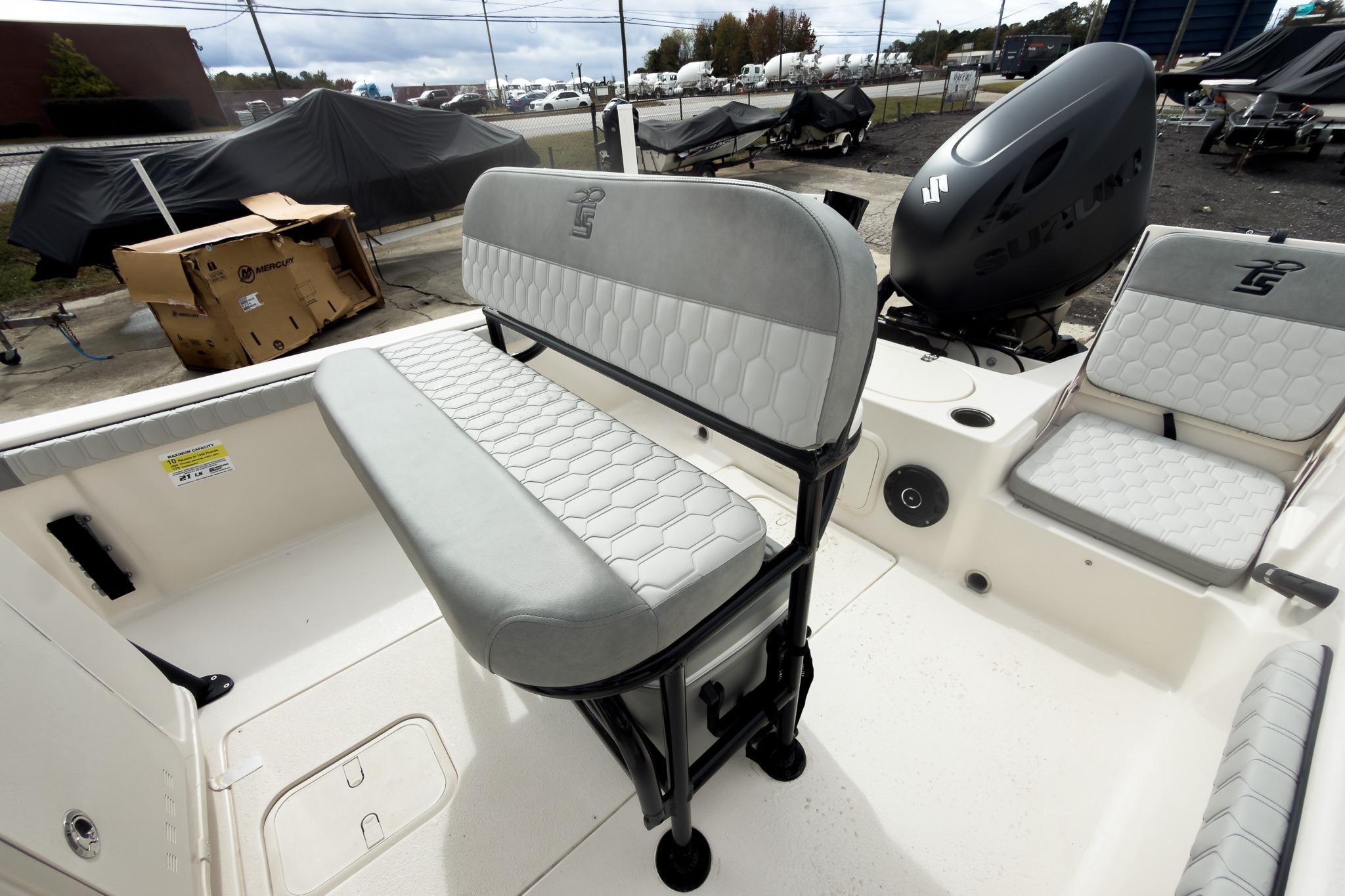 2026 Carolina Skiff 21 LS boat interior with seating and motor, displayed outdoors.