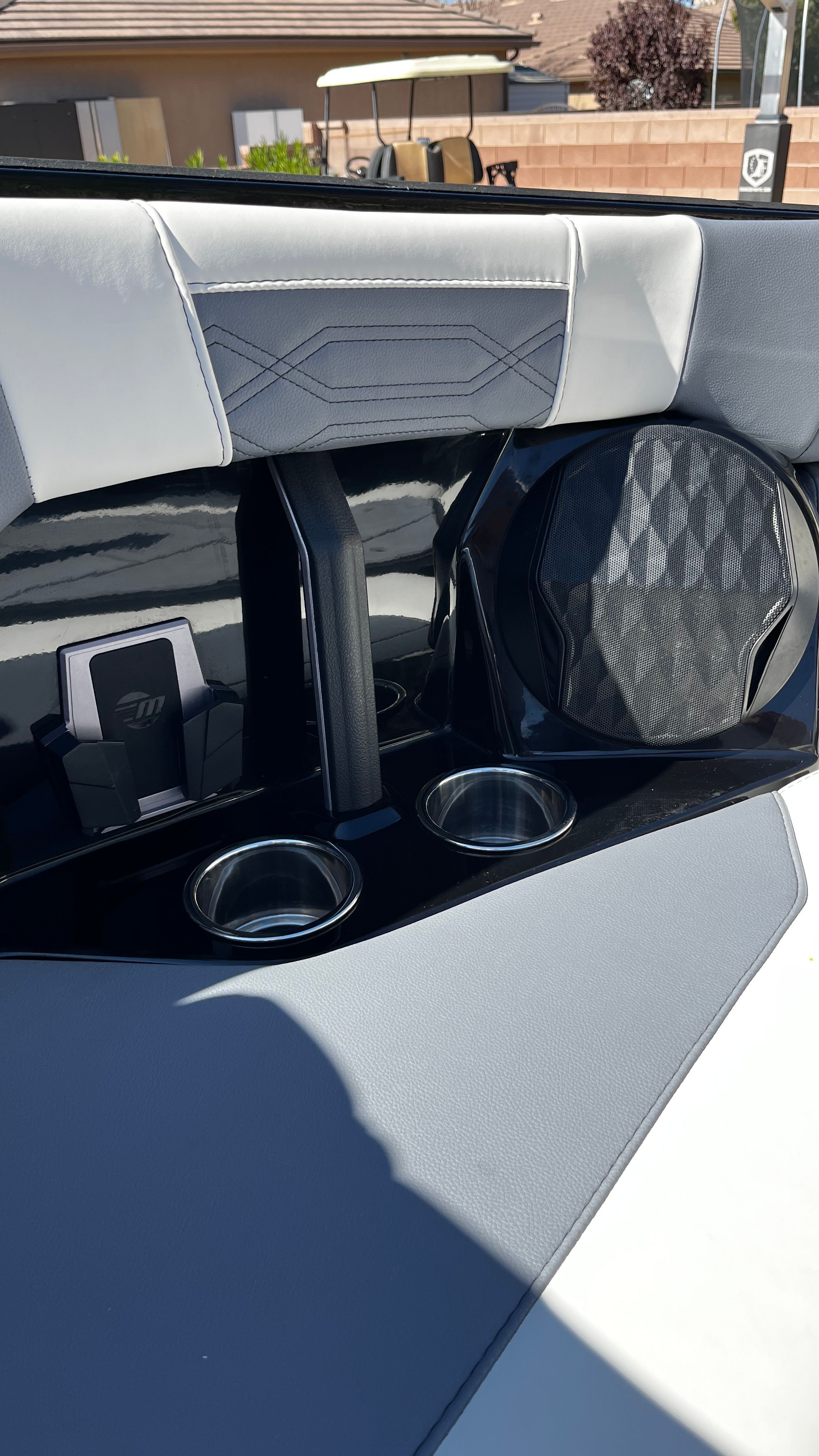Close-up of a Malibu Wakesetter 26 LSV interior with speaker and cup holders.