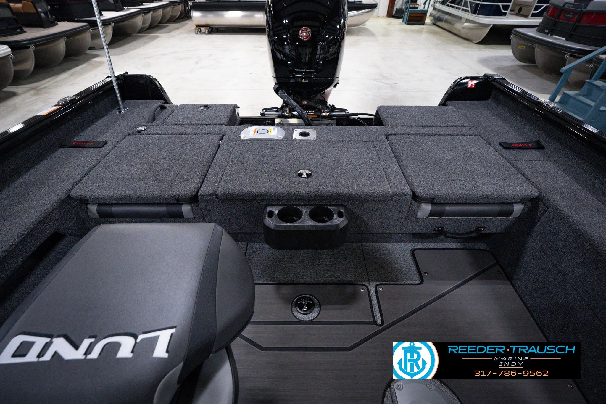2026 Lund 1875 Impact XS SS boat interior with seating and storage compartments.