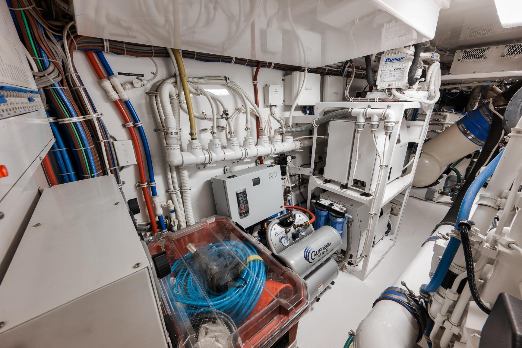 Engine room of 2015 Hatteras GT70 yacht with complex piping and machinery.
