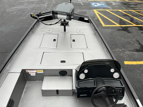 2024 Lowe Legacy boat interior with steering console and storage compartments.