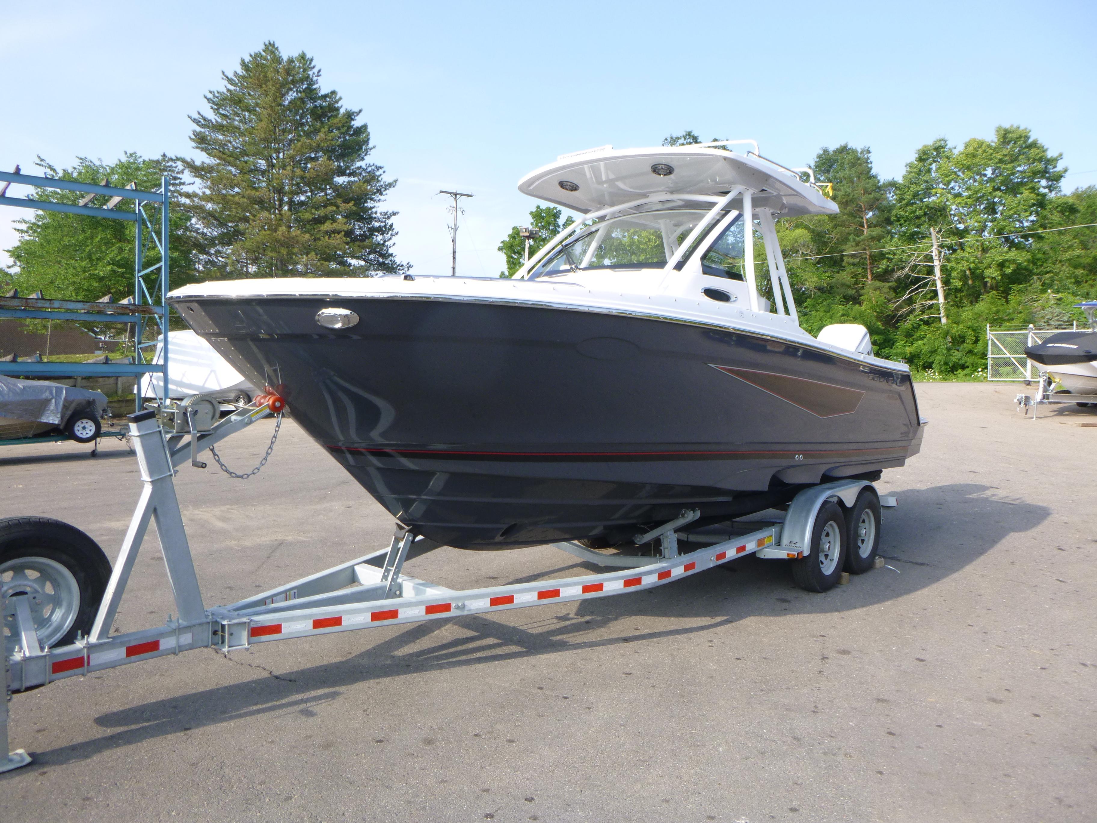 2025 Solara S-250 CW boat on trailer, parked outdoors with trees in background.