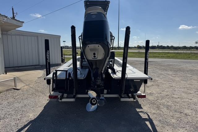 2025 Majek 24 Reaper boat on trailer, rear view, parked outdoors.