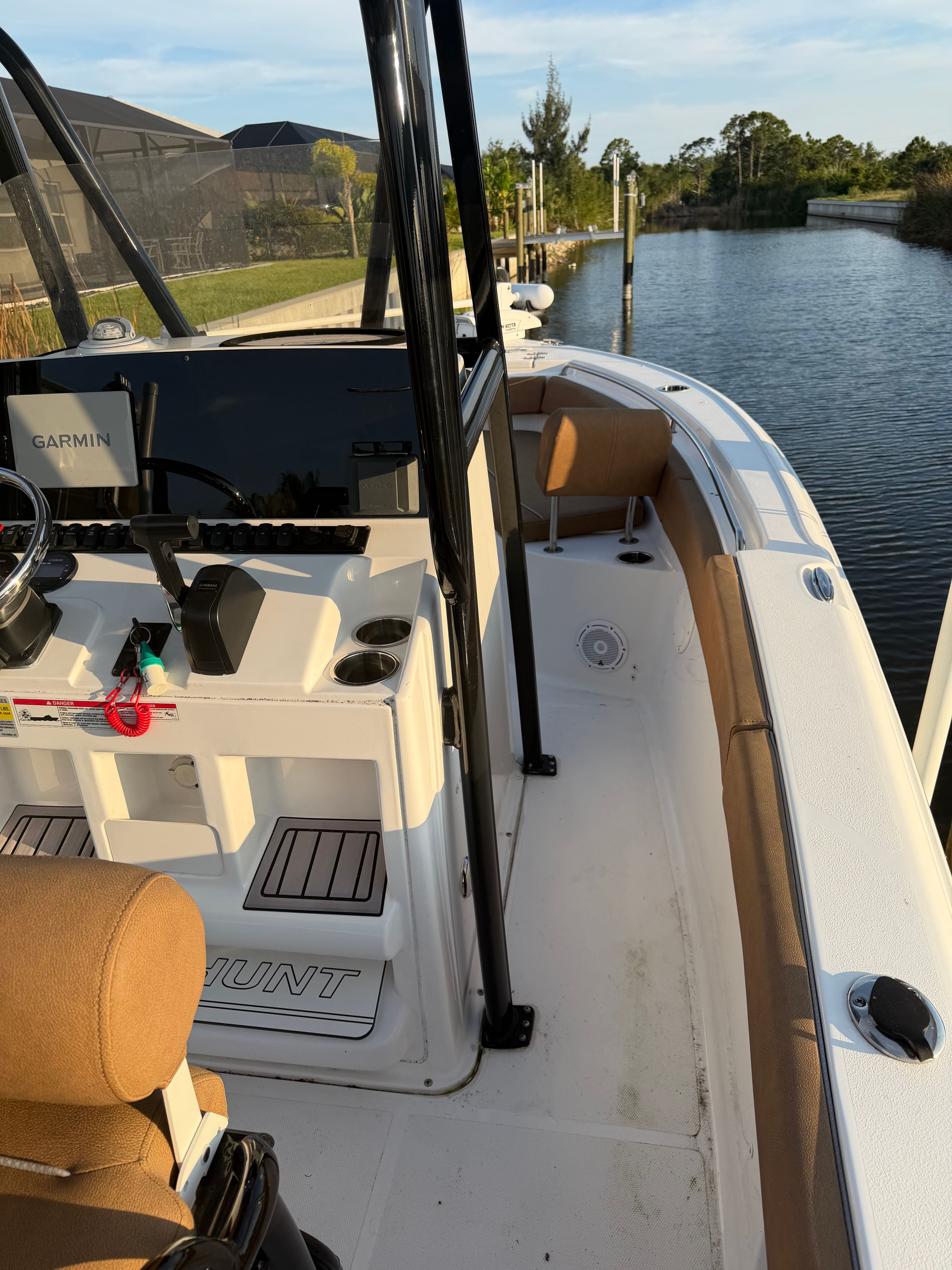 2024 Sea Hunt Ultra 219 by the water with a modern cockpit.