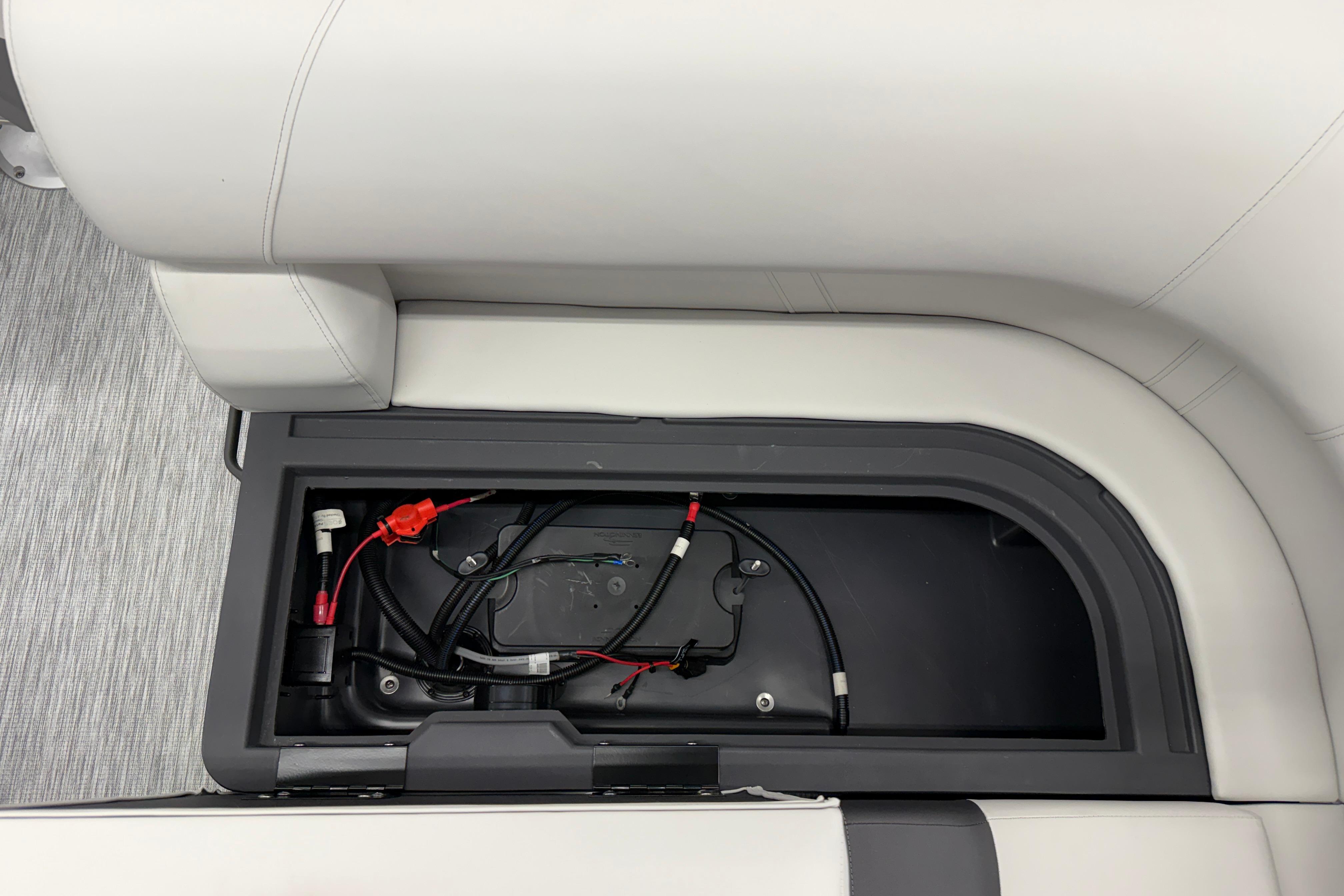 Storage compartment with wiring inside a 2026 Bennington 20 SF boat seat.