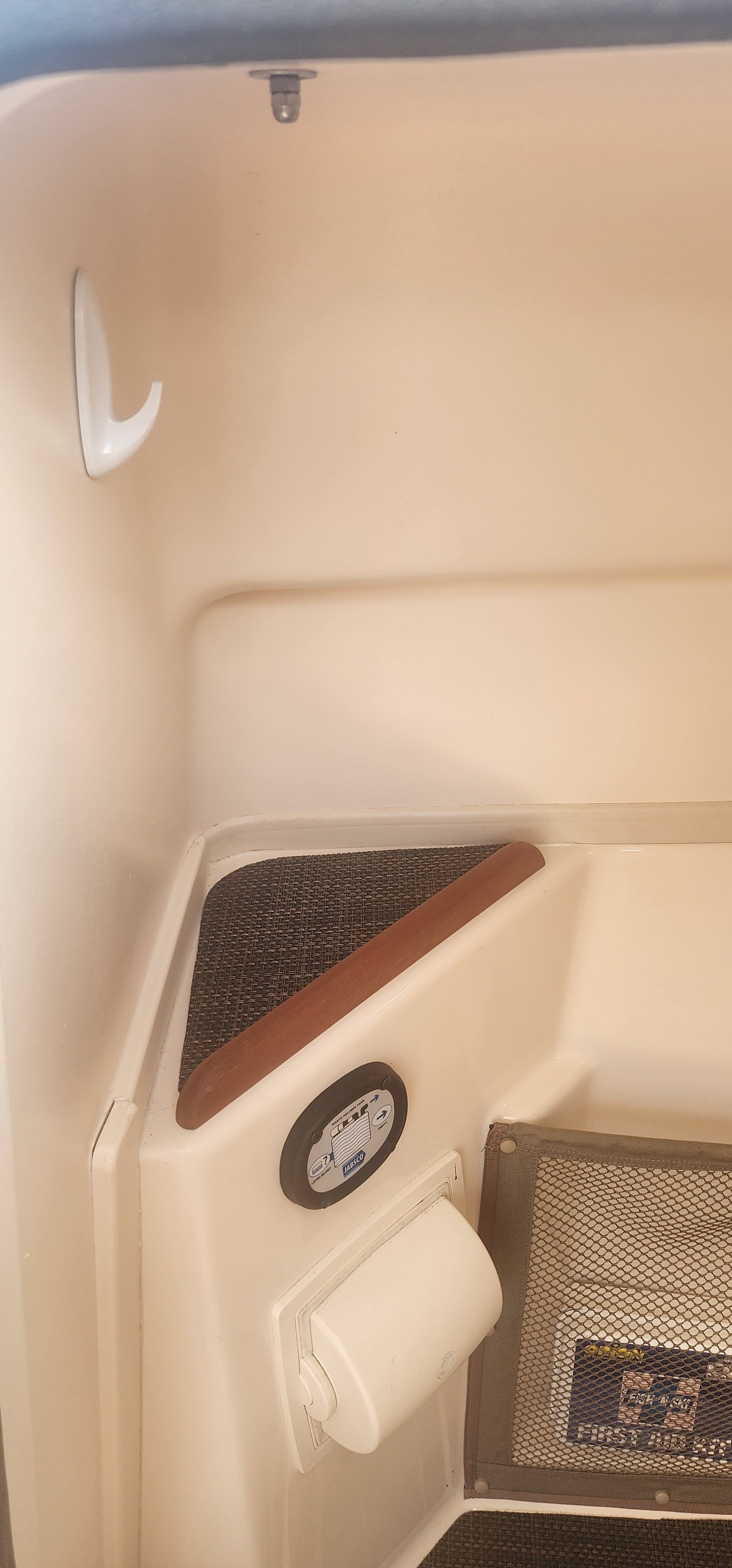 Interior of a 2015 Grady-White Freedom 275 with a small shelf and a hook.