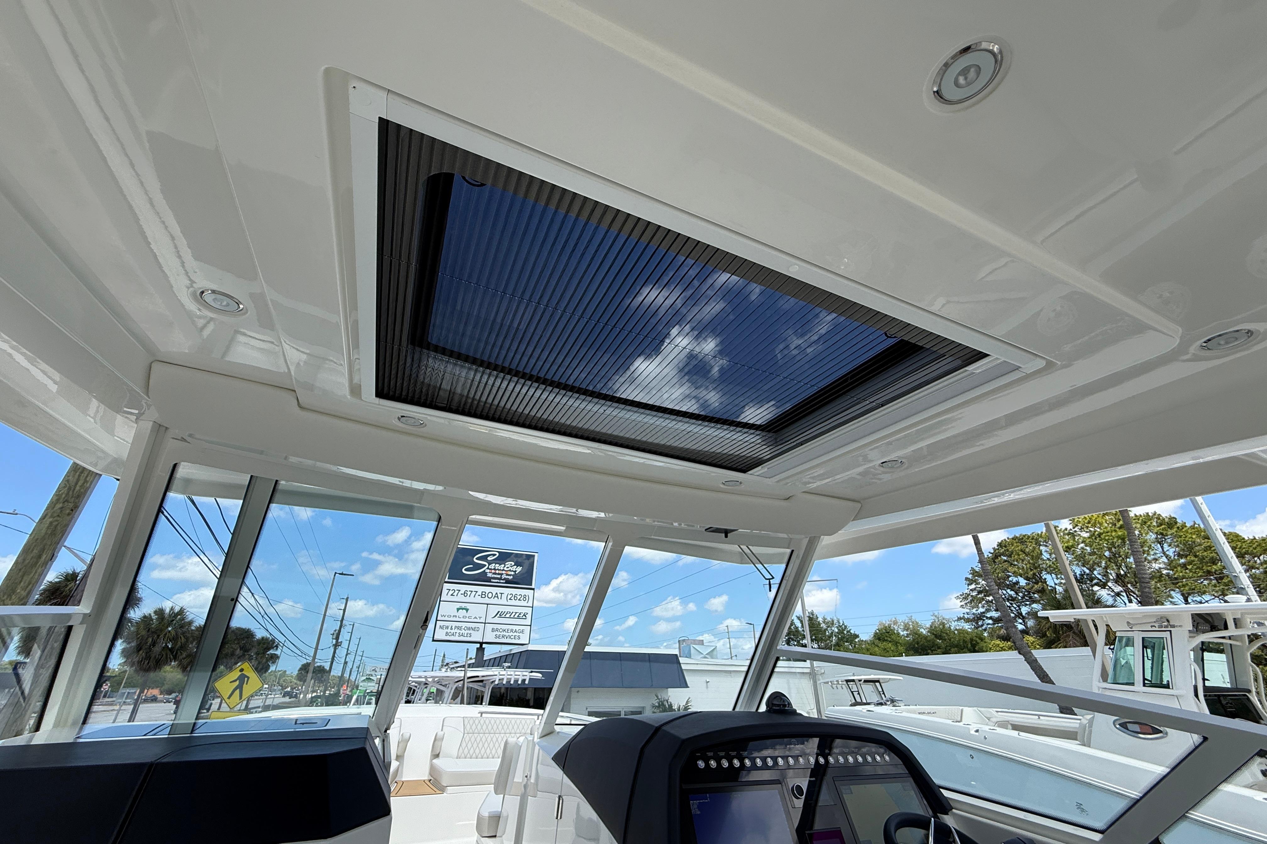 Interior view of 2026 World Cat 400 DC-X Island boat with sunroof and control panel.