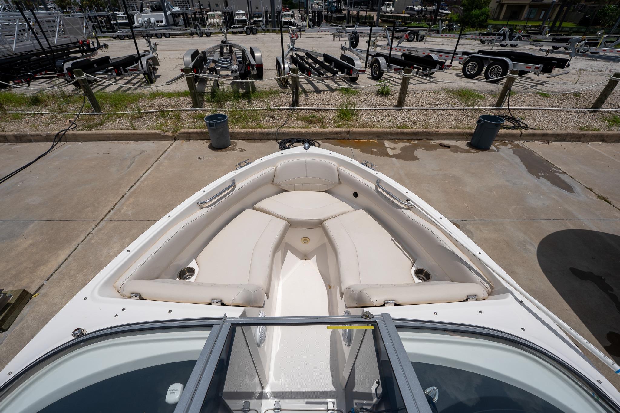 2008 Regal 2000 Bowrider boat interior with seating, parked on concrete near trailers.