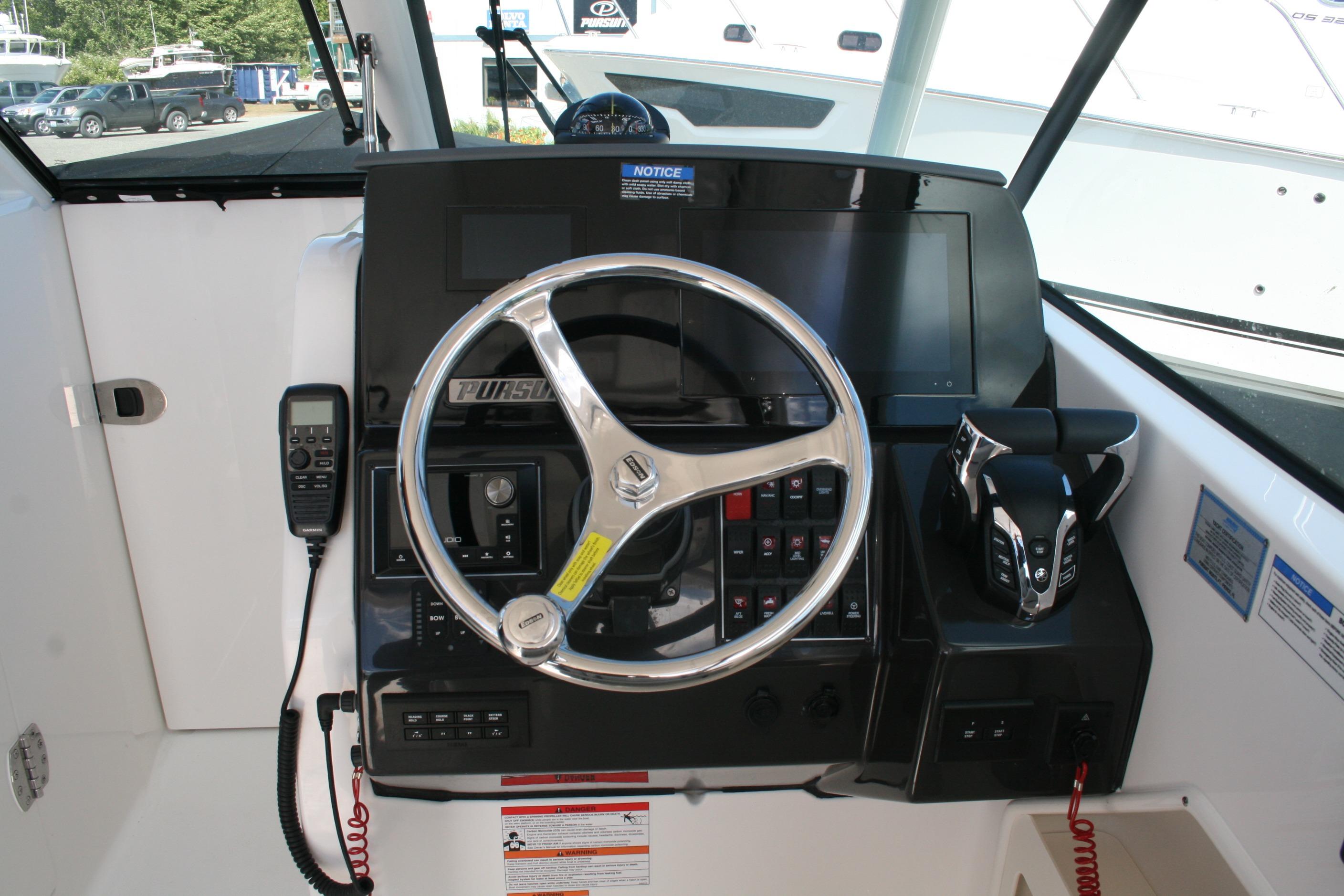 2026 Pursuit DC 266 Dual Console helm with steering wheel and control panel.