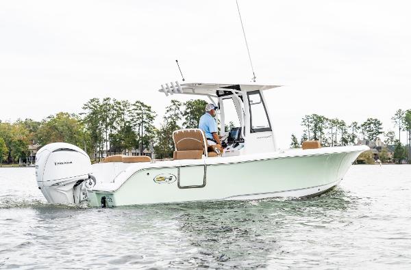 2025 Sea Hunt Ultra 235 SE boat cruising on a calm lake.