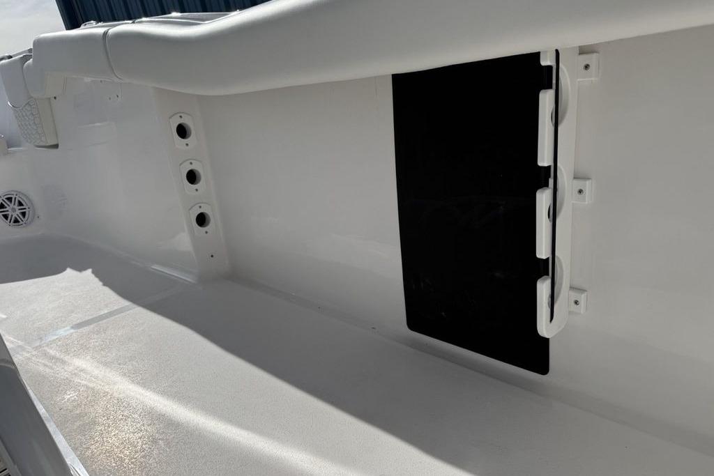 Interior view of 2026 Tidewater 232 LXF boat, featuring sleek white design and storage compartments.
