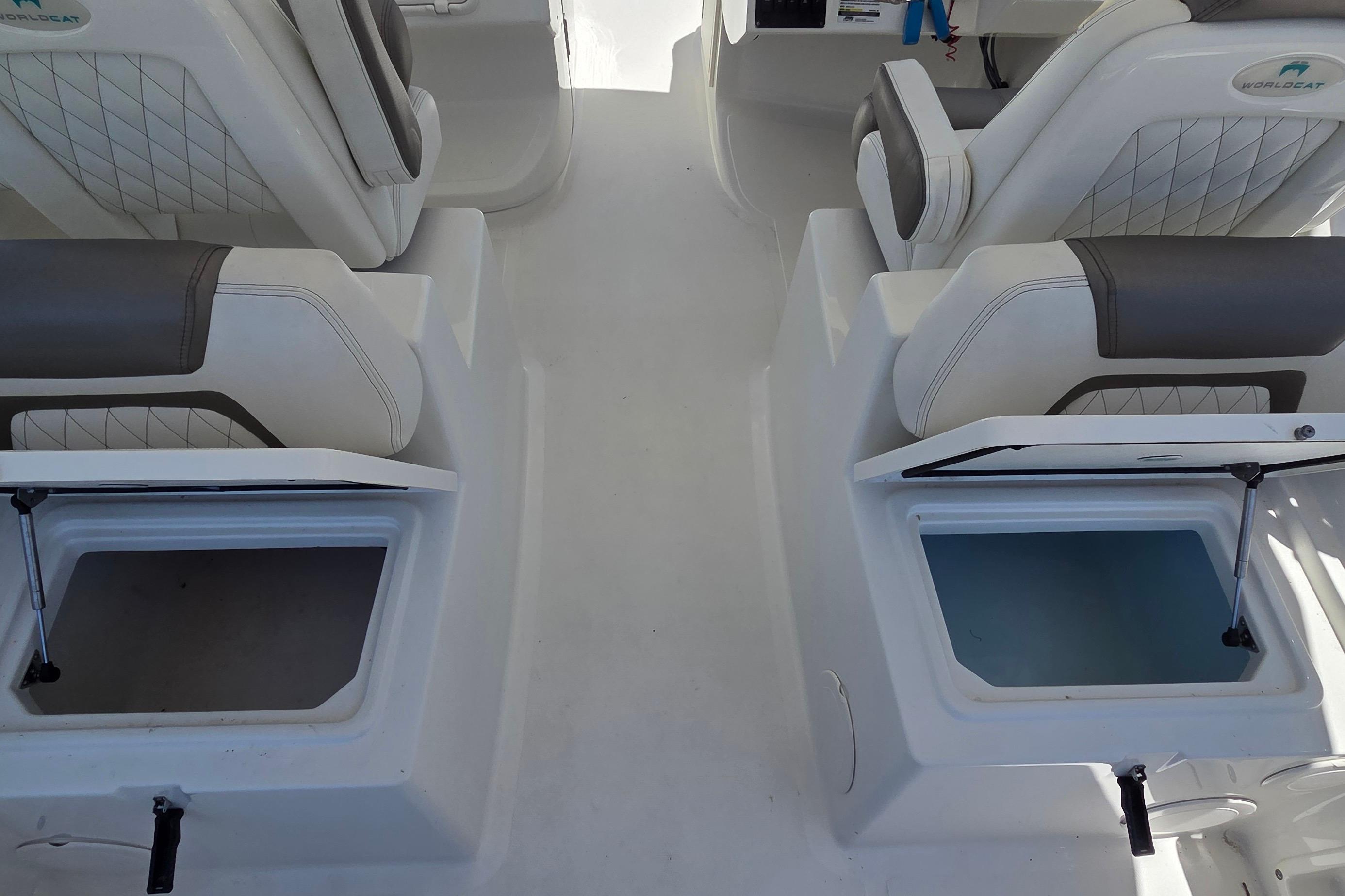 2022 World Cat 255 DC boat interior with open storage compartments and cushioned seats.