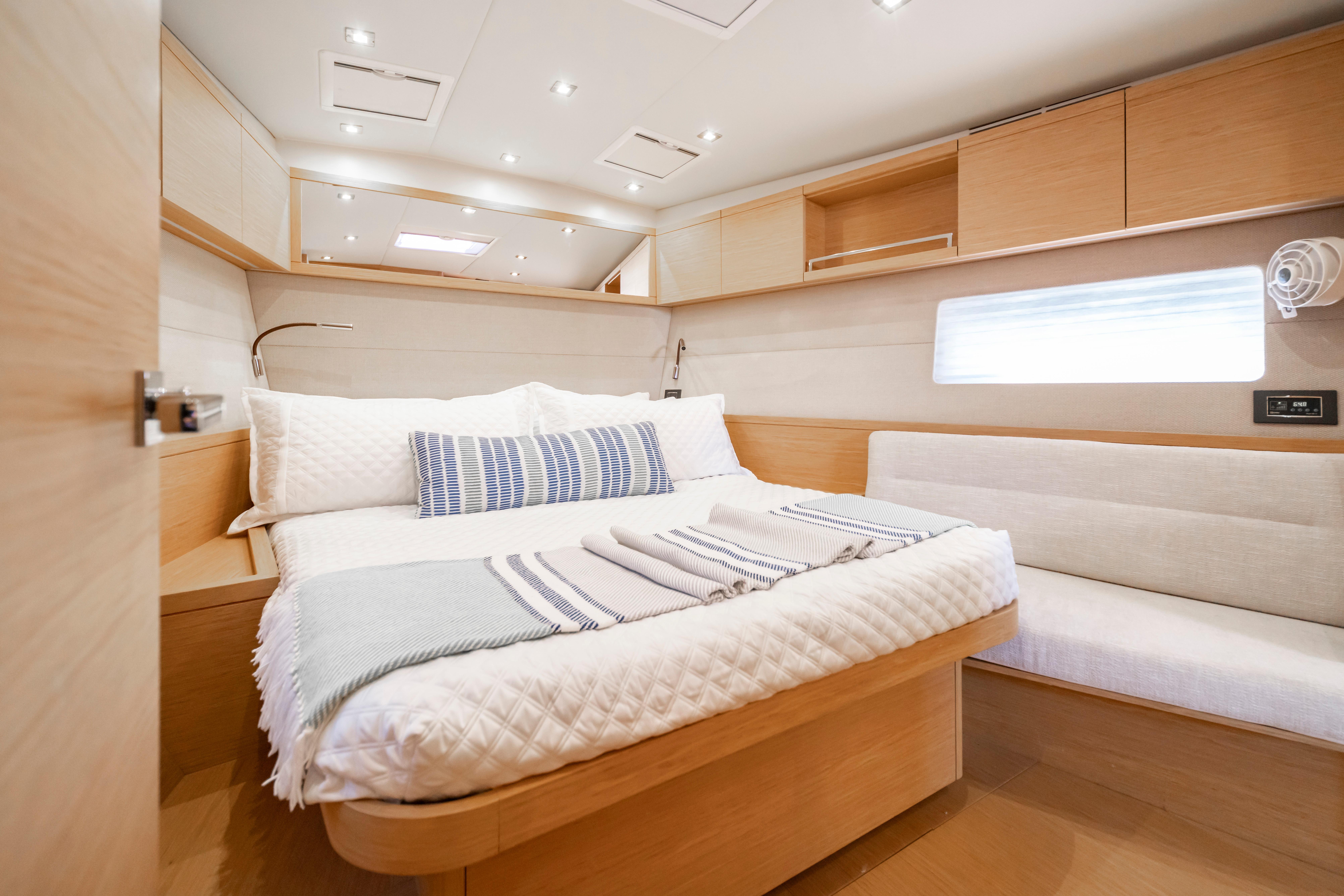 Luxurious interior cabin of 2016 Grand Soleil 58 yacht with cozy bed and modern design.