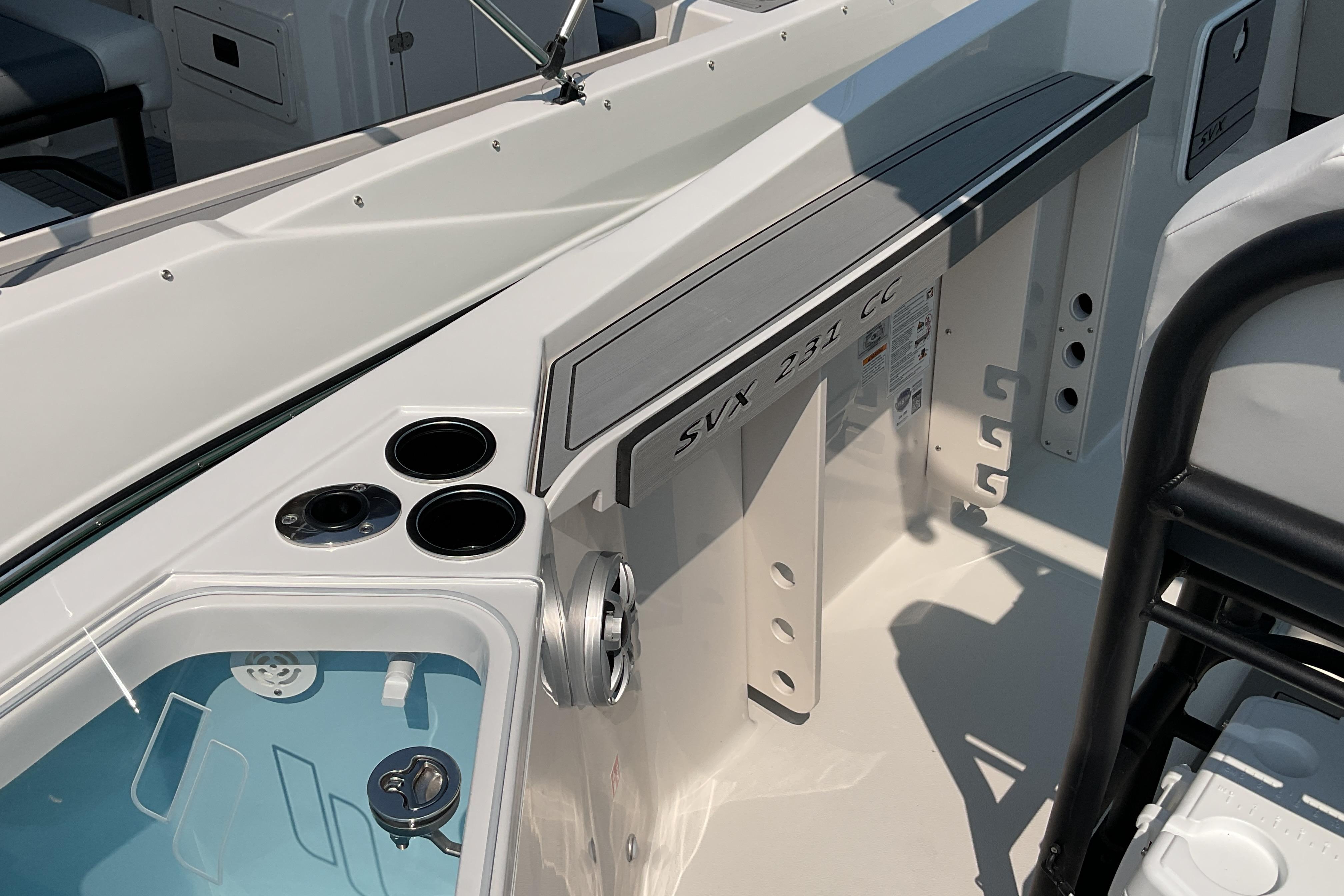 2026 Starcraft SVX 231 OB CC boat interior with cup holders and storage compartments.